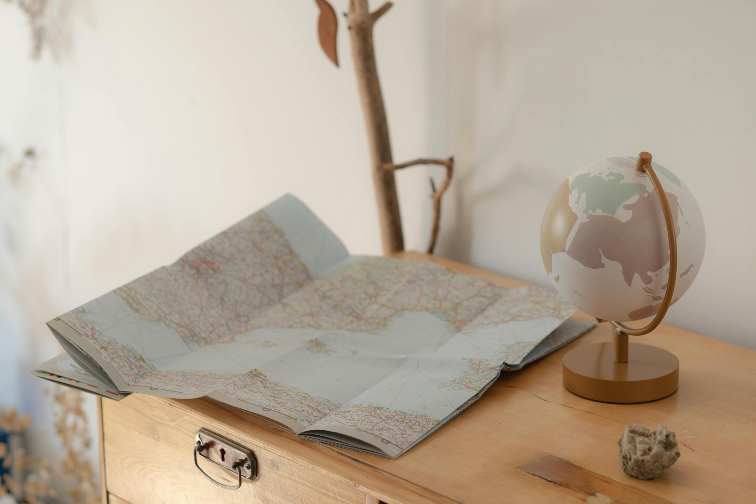 a desk with a map and a globe on top of it