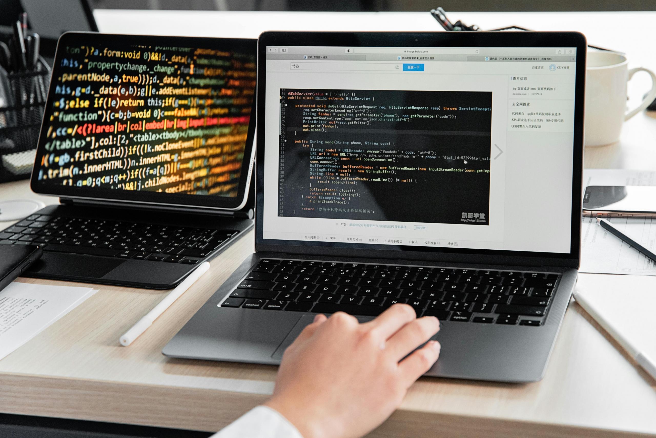 person using laptop with code