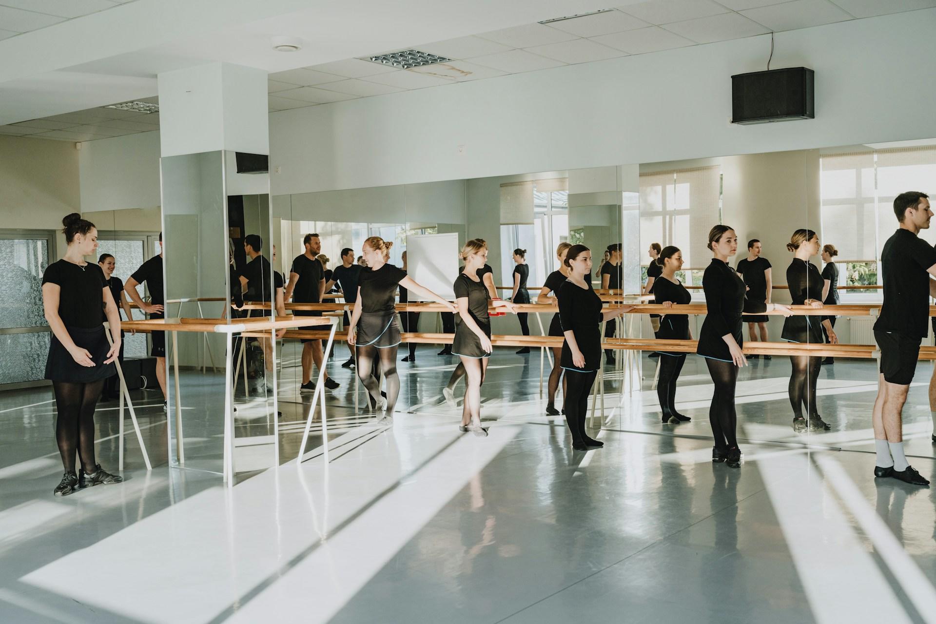Women in a studio at the barre.
