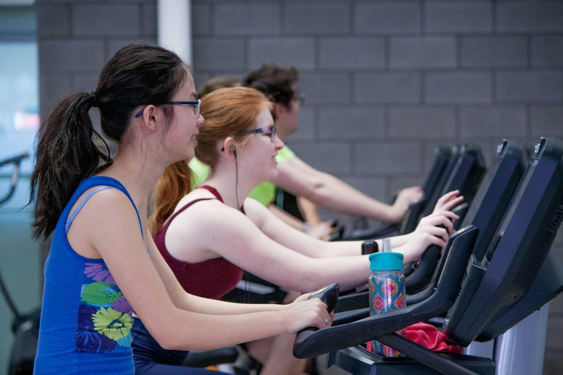 Women exercising on gym machines. 