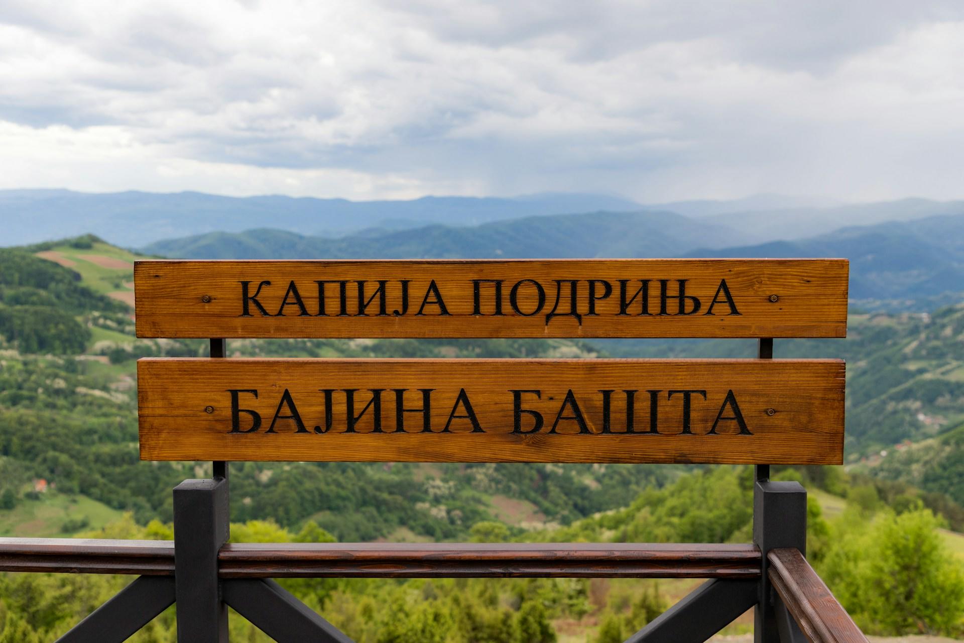 a sign of Cyrillic texts on a mountain.