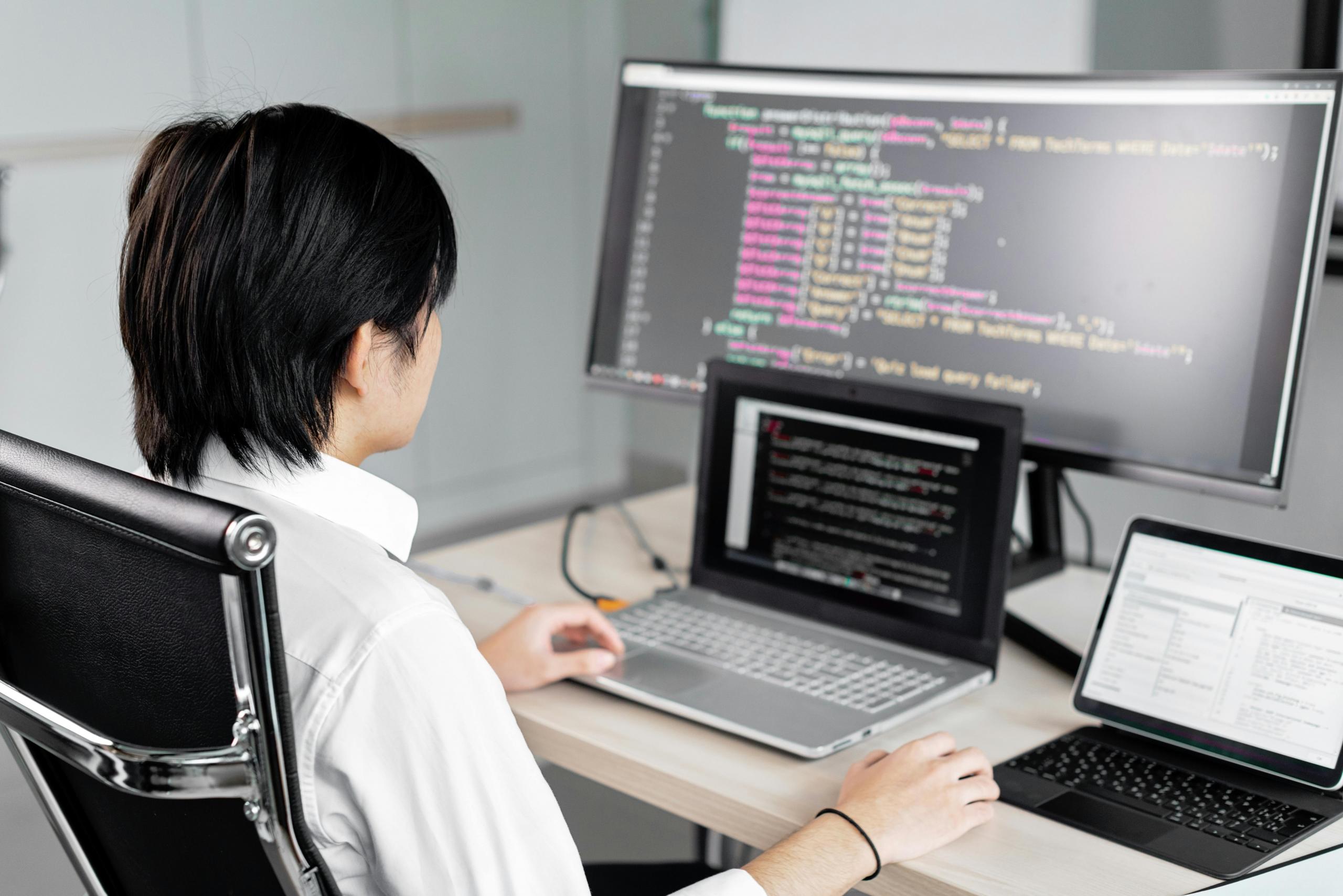 A man sitting in front of the computer while working
