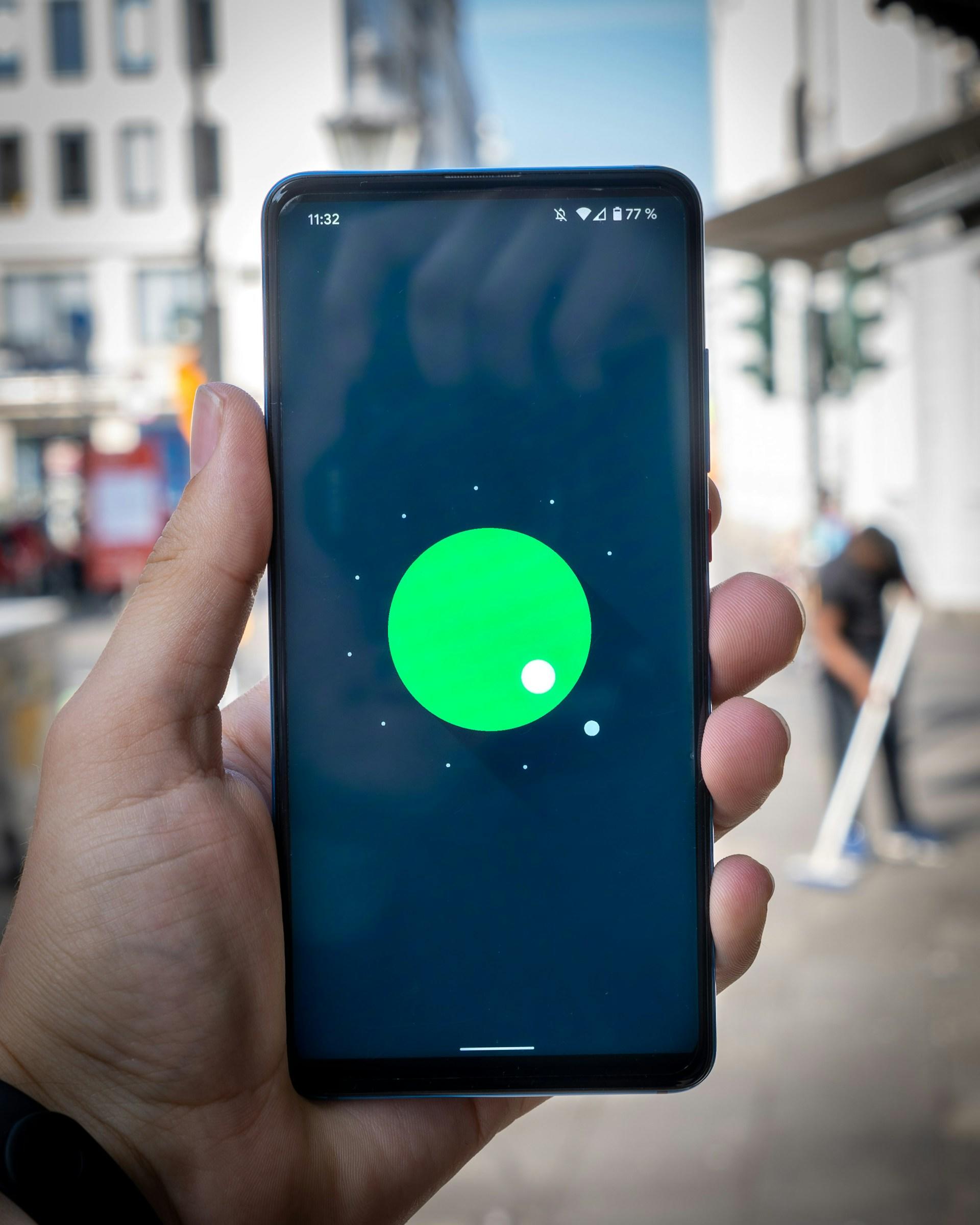 A hand holding a smartphone so the screen is visible.
