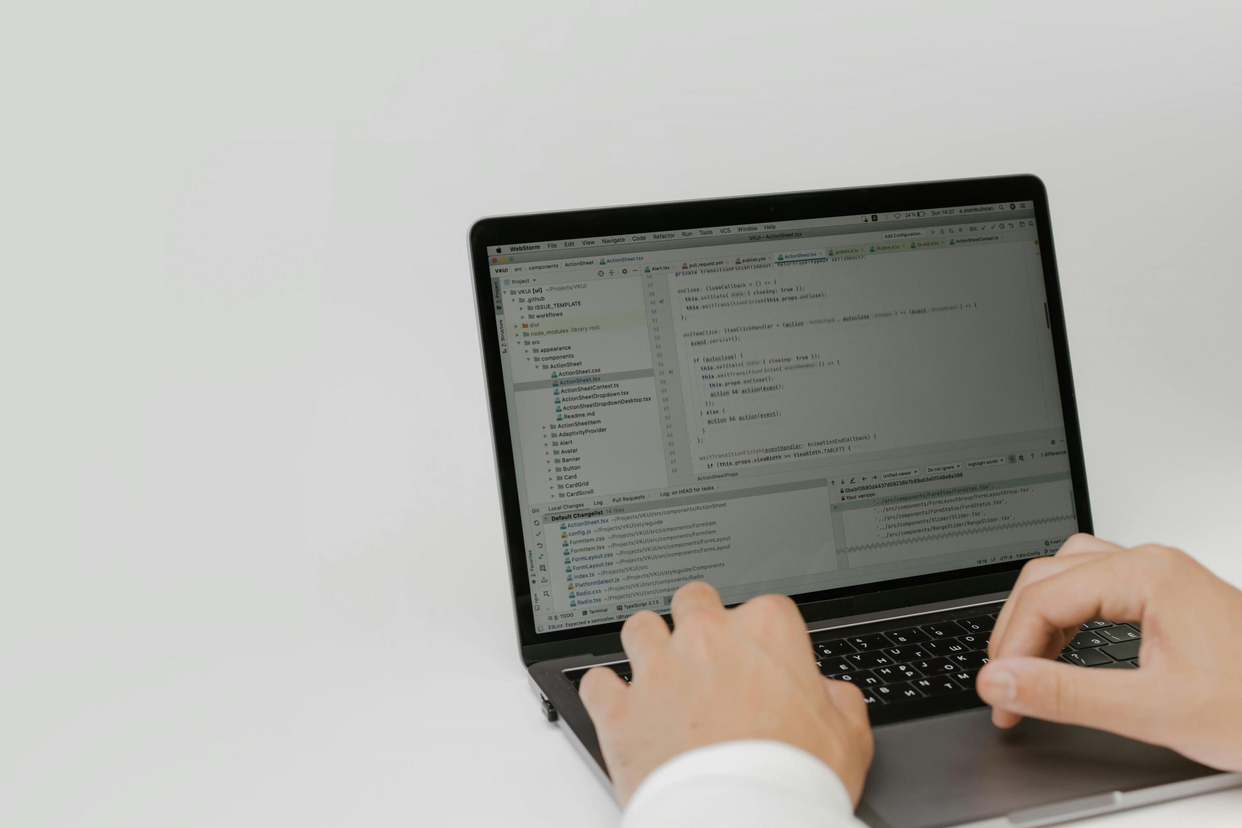 Close-up shot of a person using code on a laptop