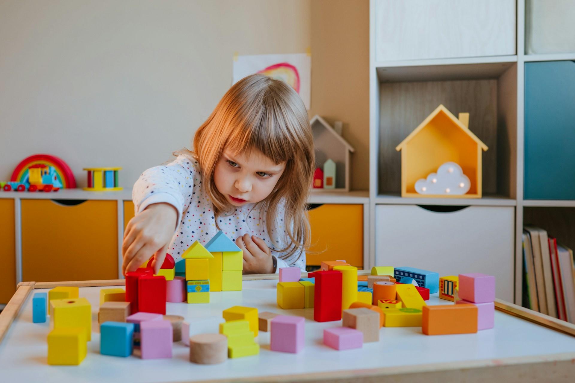A child plays with colourful blocks