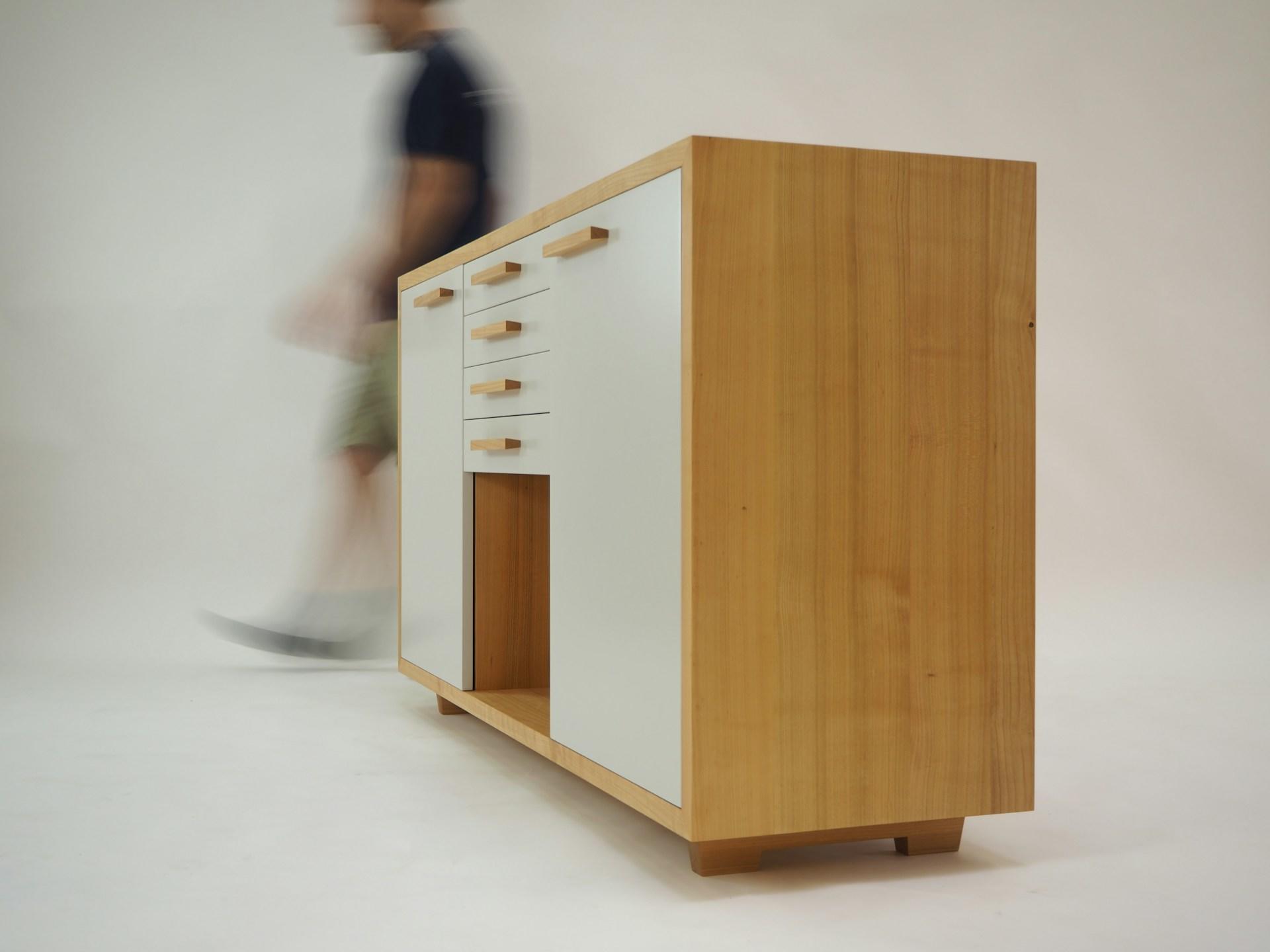 person standing beside a cabinet