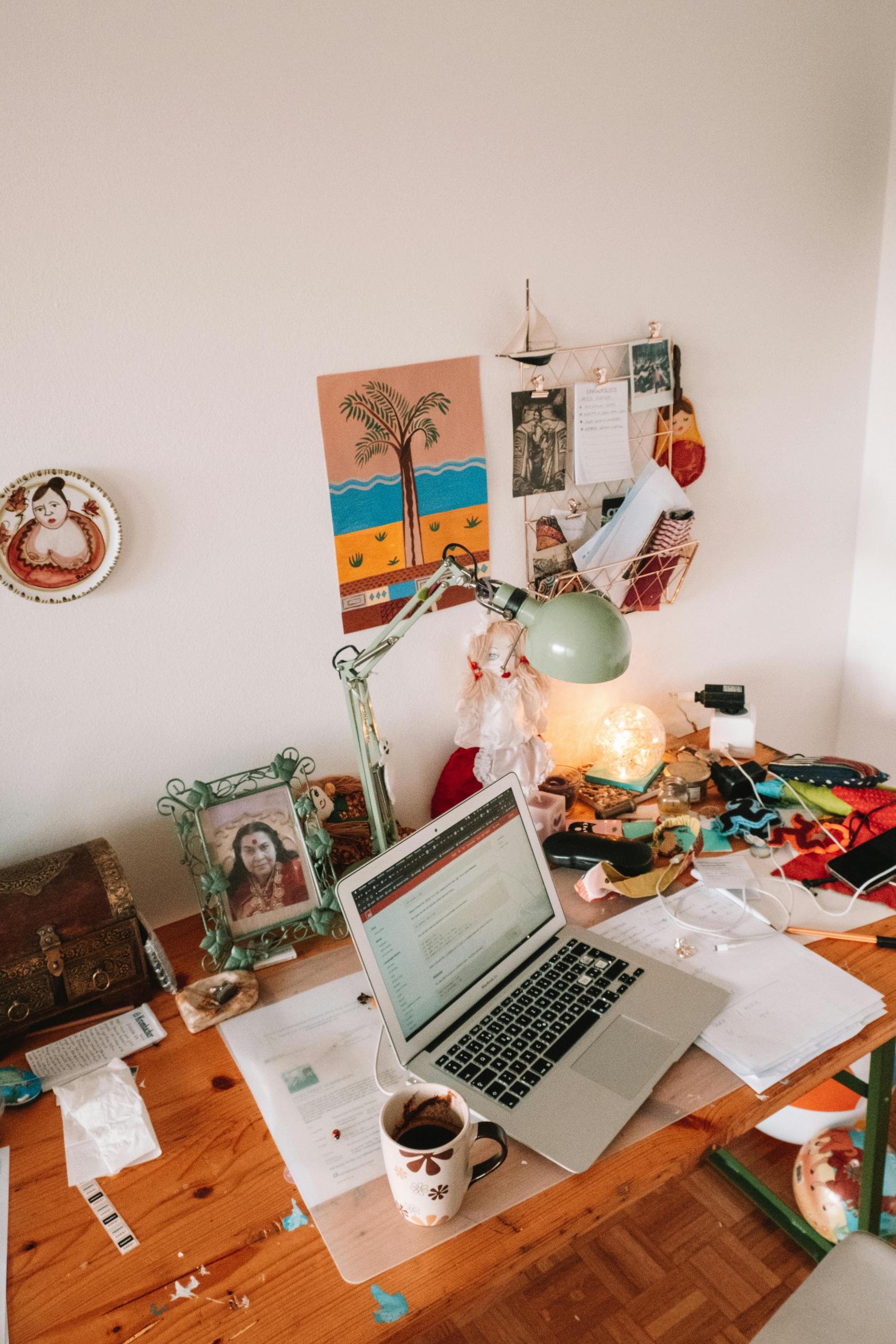 Laptop on table beside a mug