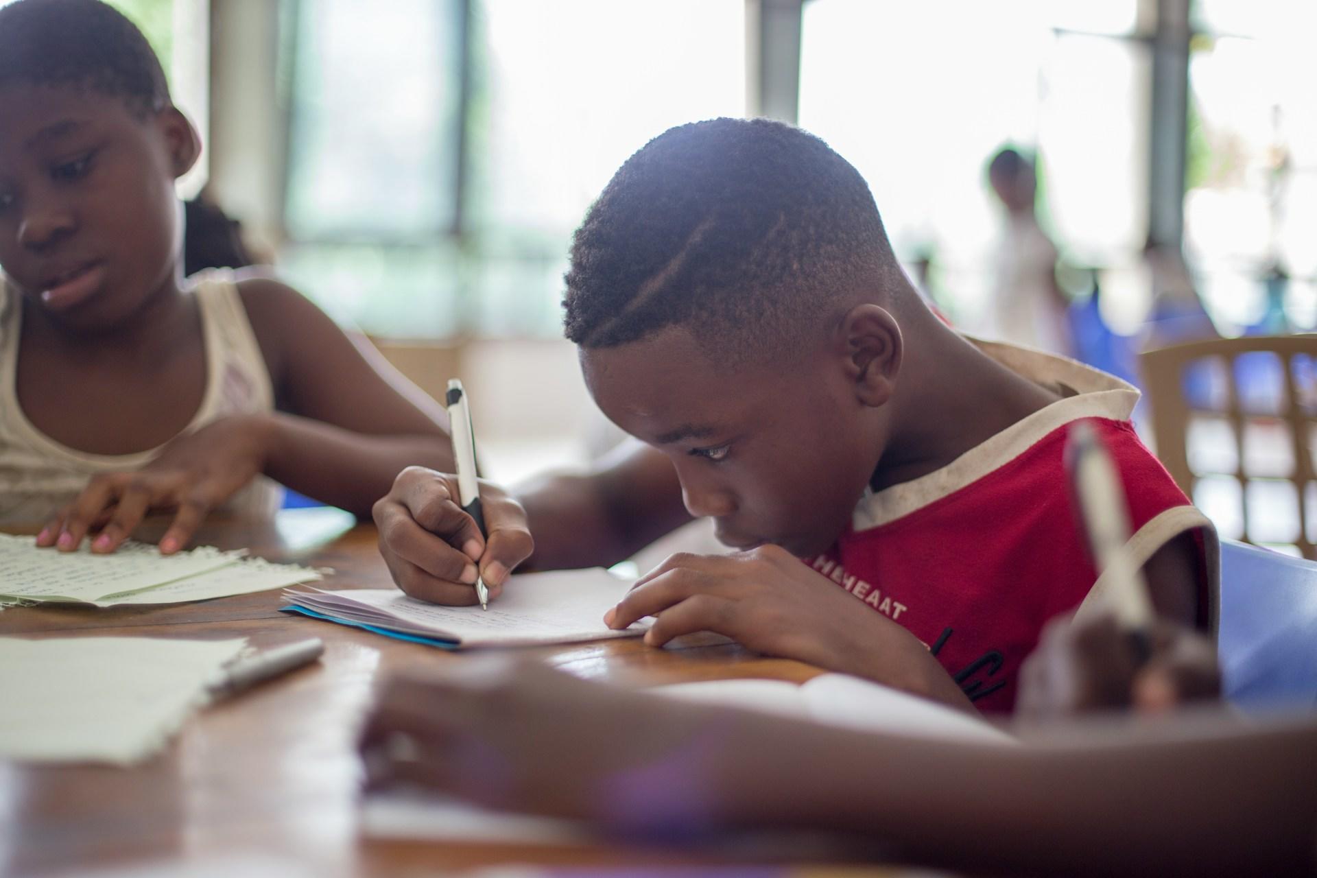 Primary school students working at a table.
