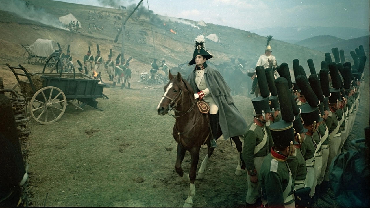 a soldier riding a horse wihle surrounded by armies. 