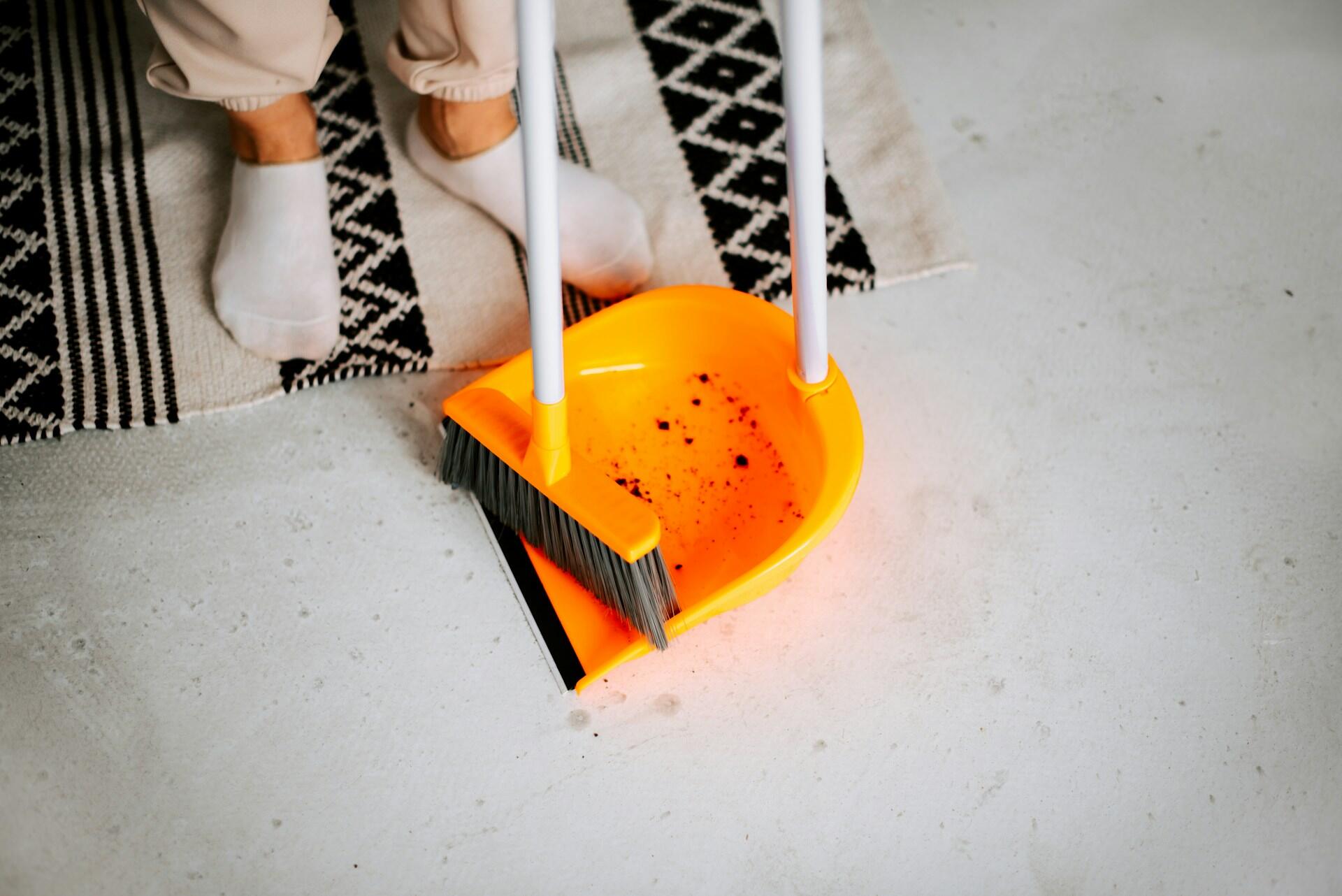 A yellow broom and dust pan.