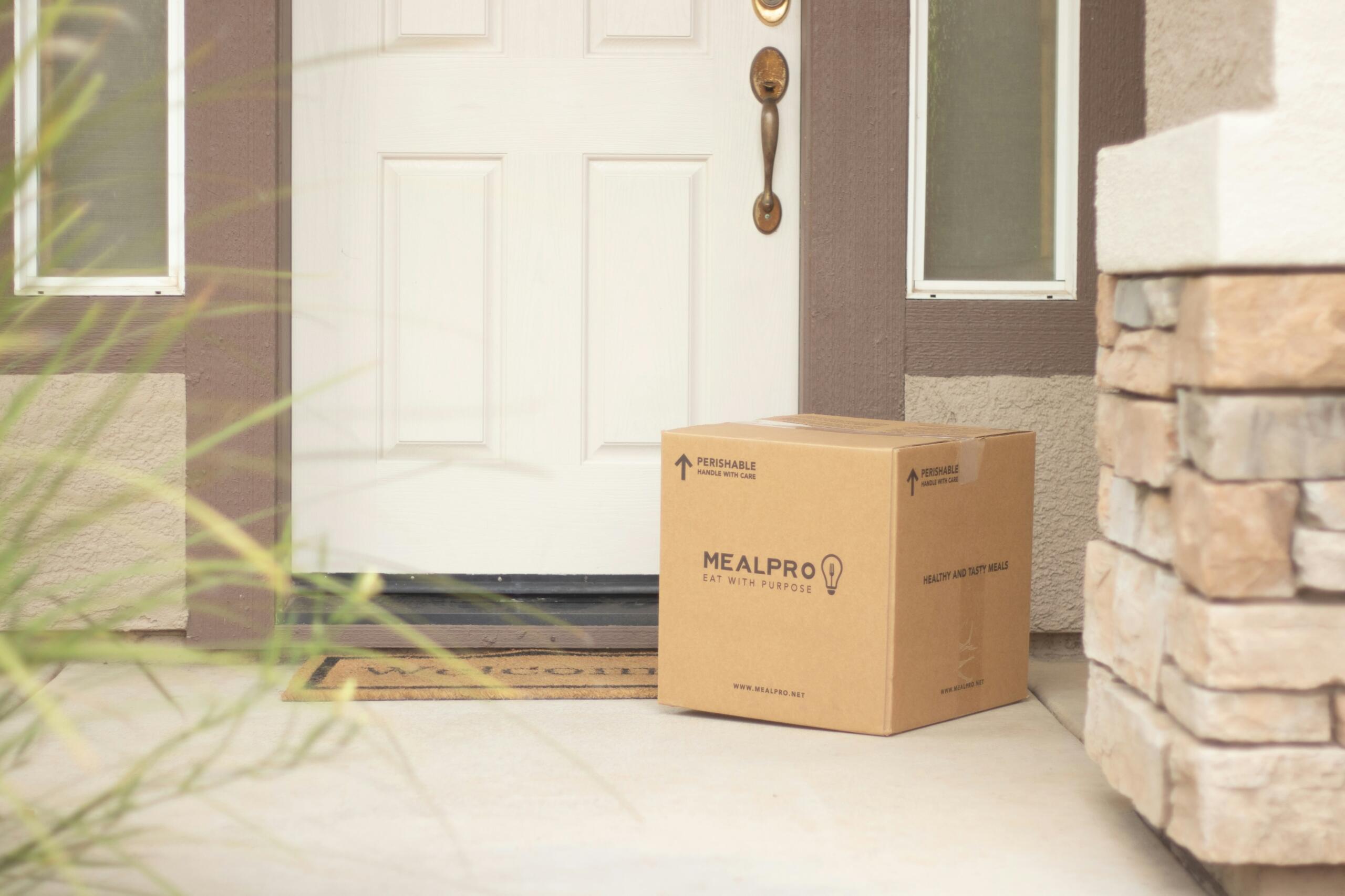 delivery box on a doorstep beside a white front door