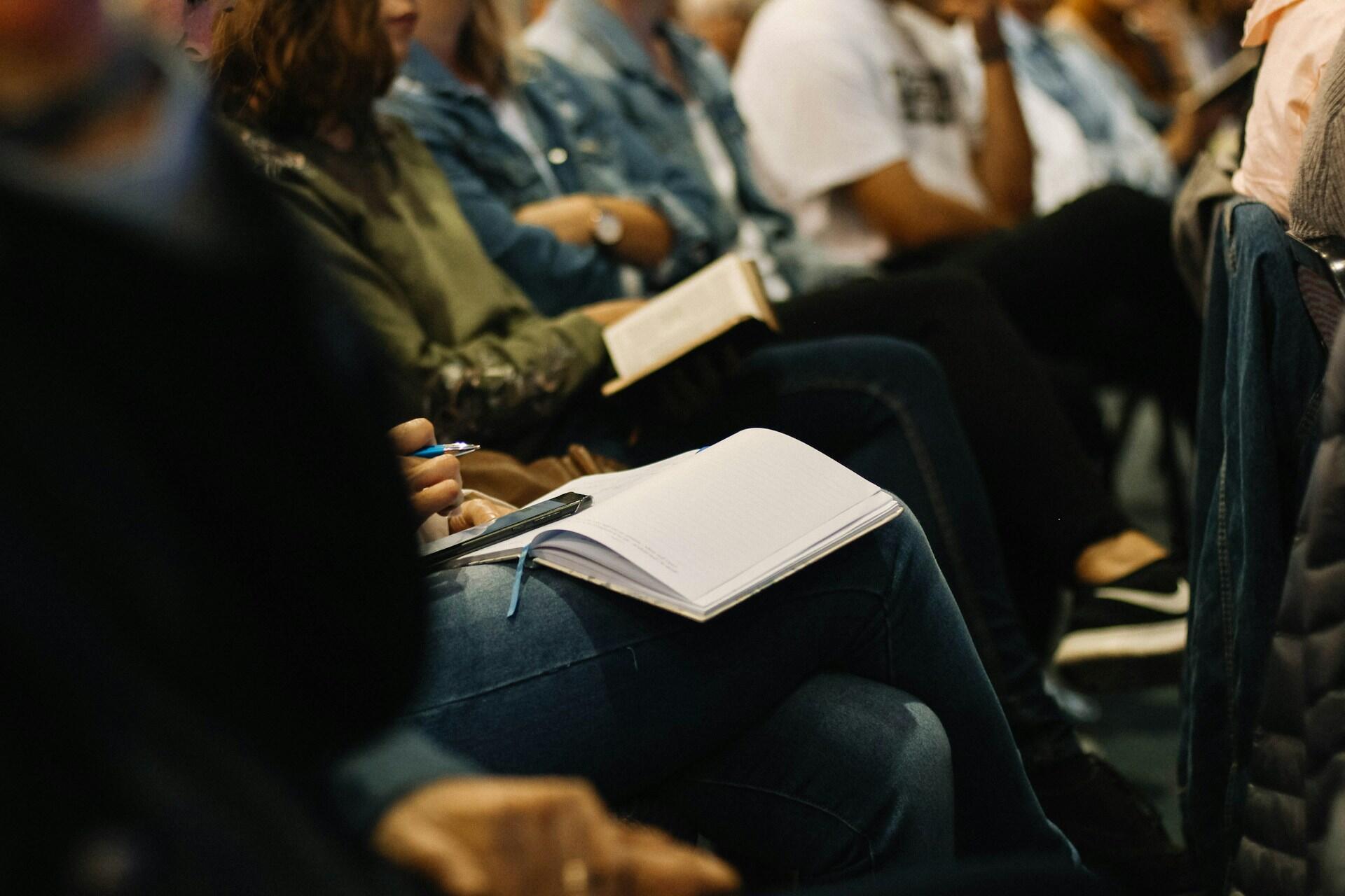 Several adult students in a class or presentation.