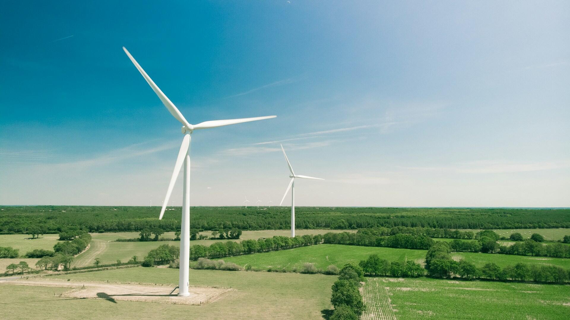 Two wind turbines on a sunny day. 
