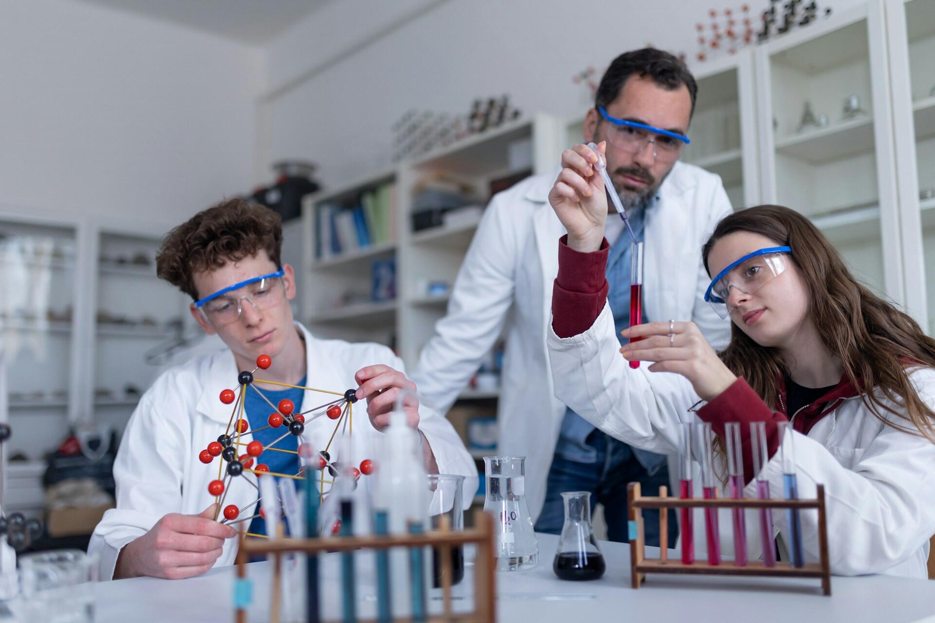 A teacher oversees students' work.