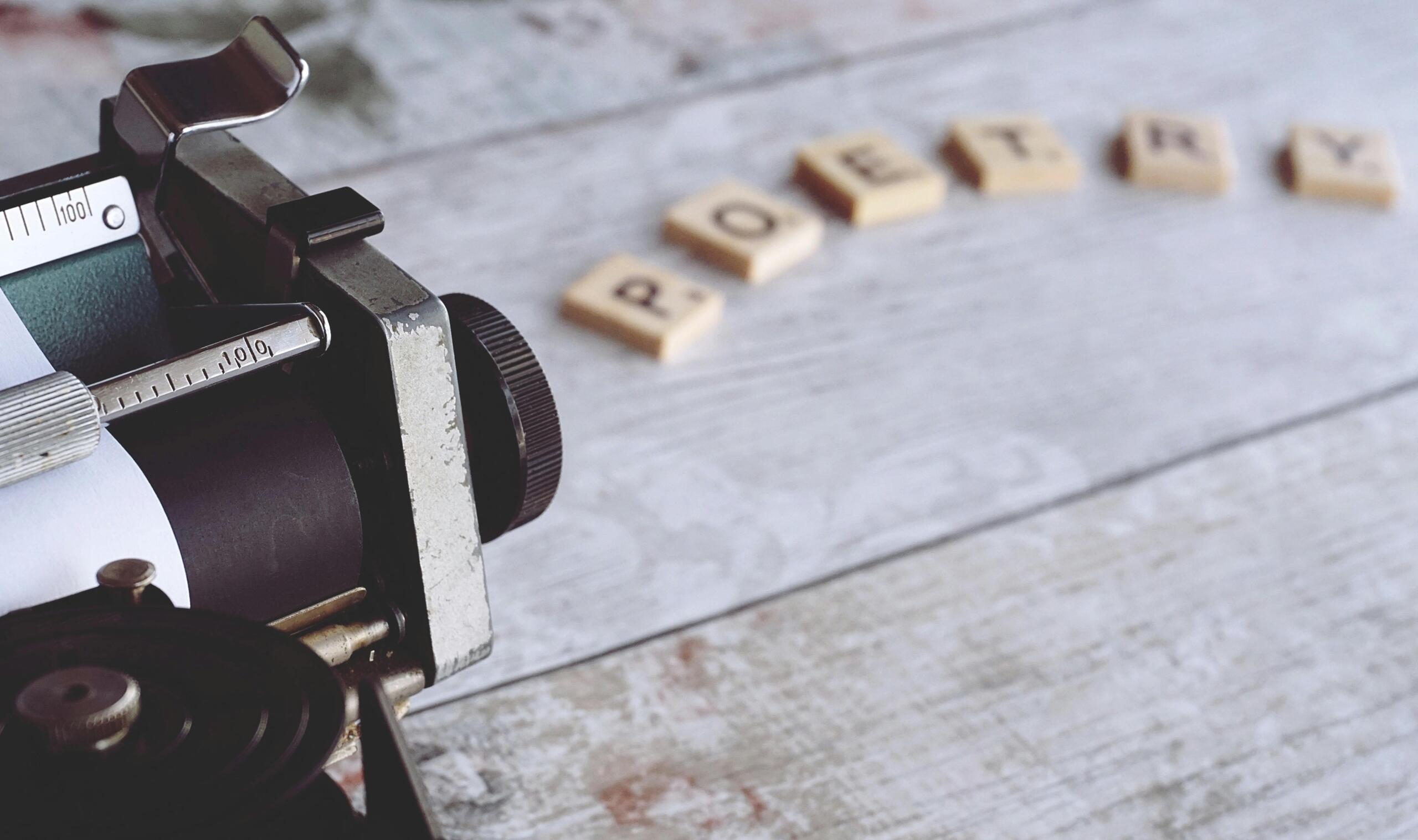 A close-up shot of a vintage typewriter with metal typebars and a sheet of paper inserted.