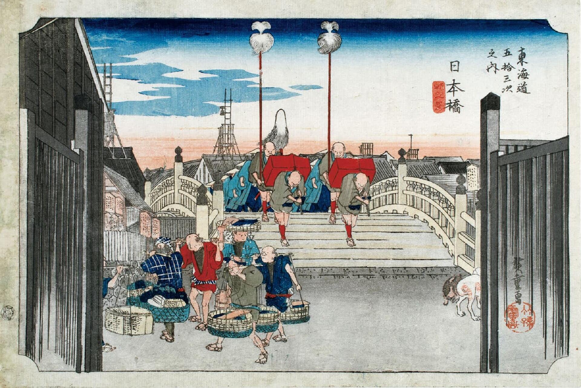 People, carrying baskets of goods, cross a stone bridge. 