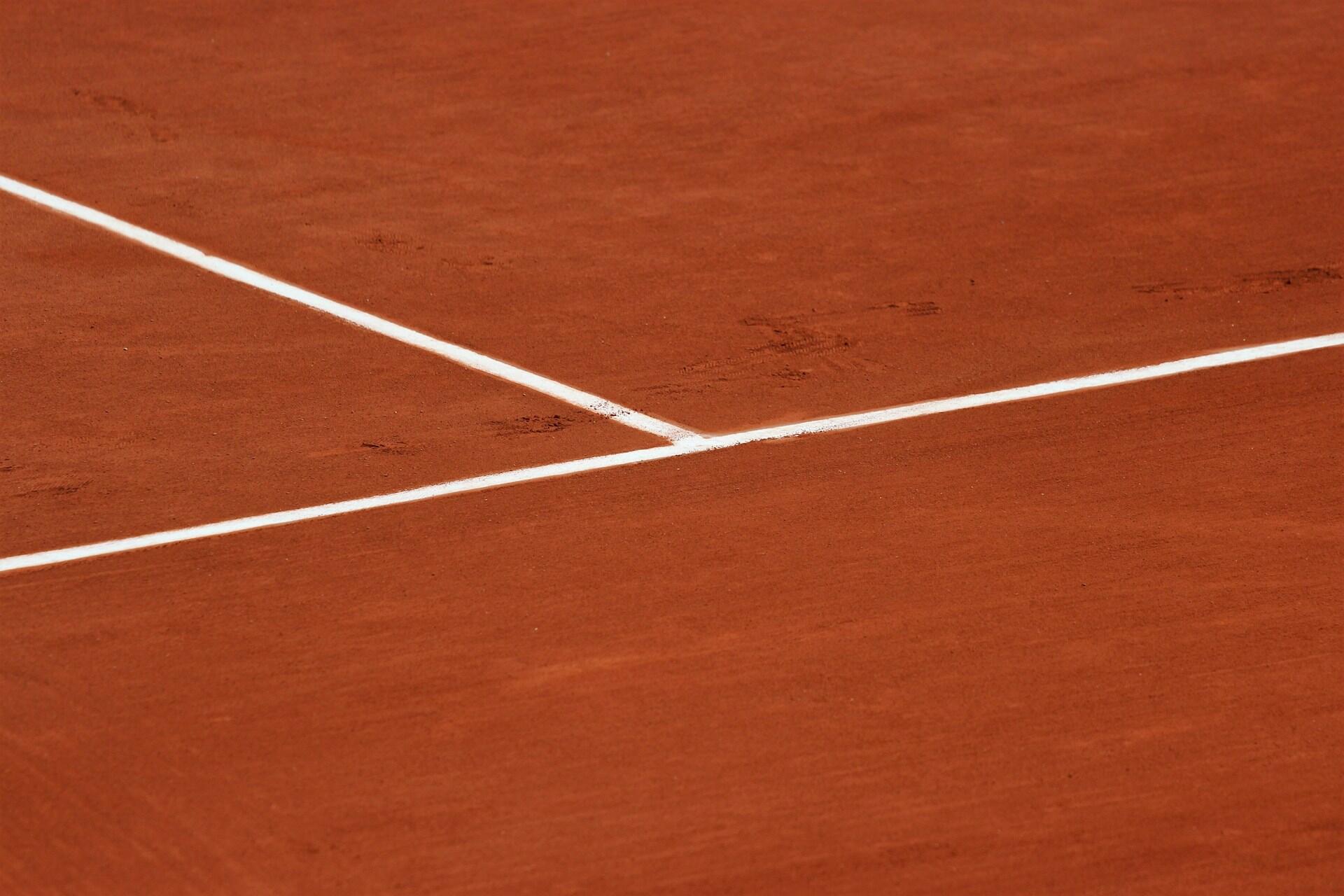 A clay tennis court with no players.