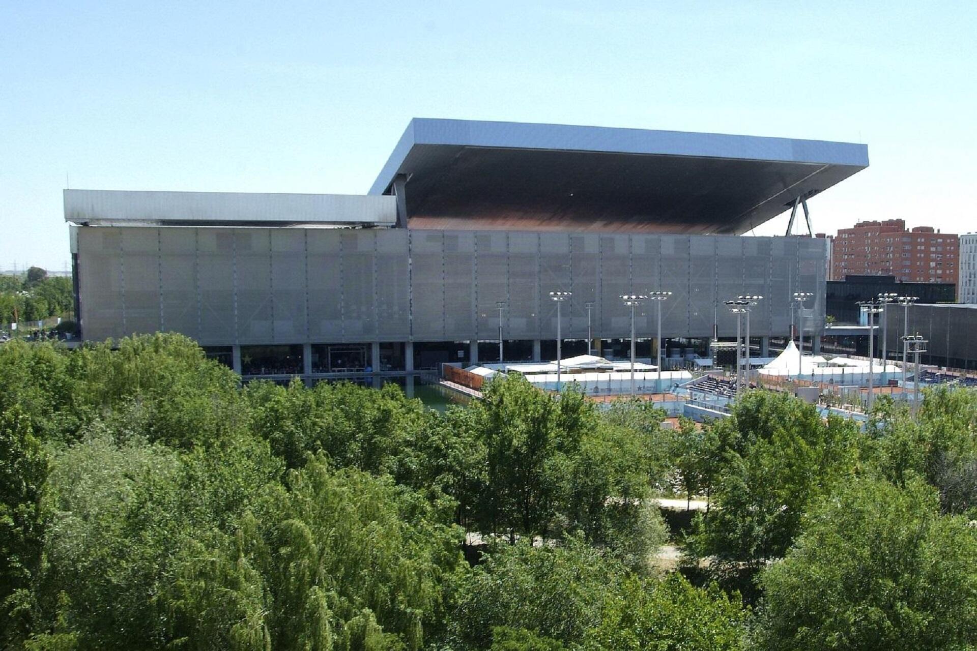A grey building surrounded by trees.
