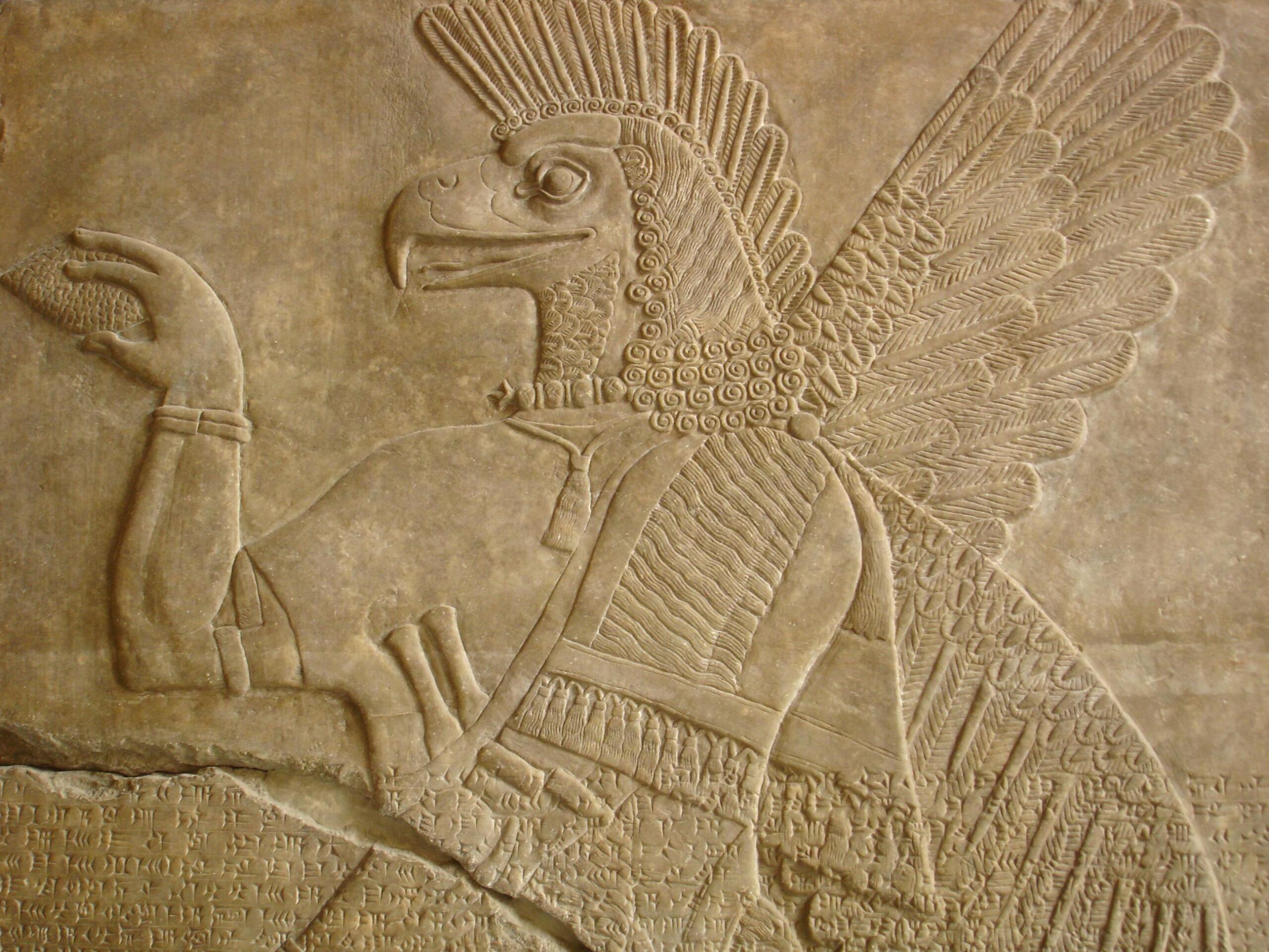 Ancient Babylonian stone relief depicting a mythological figure with detailed carvings.