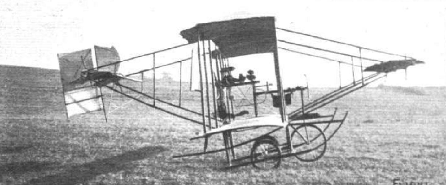 A biplane in a field on a sunny day.