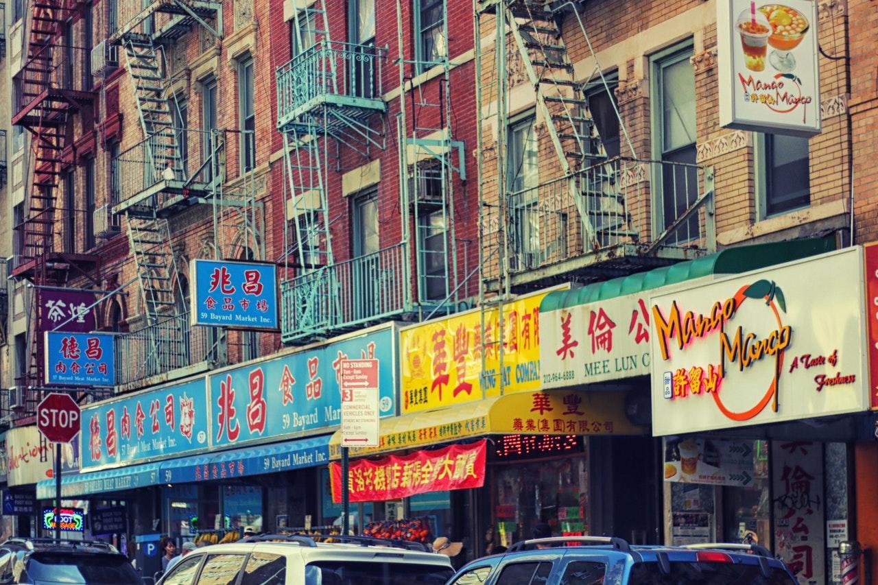 a city street with shops with chinese writing displayed
