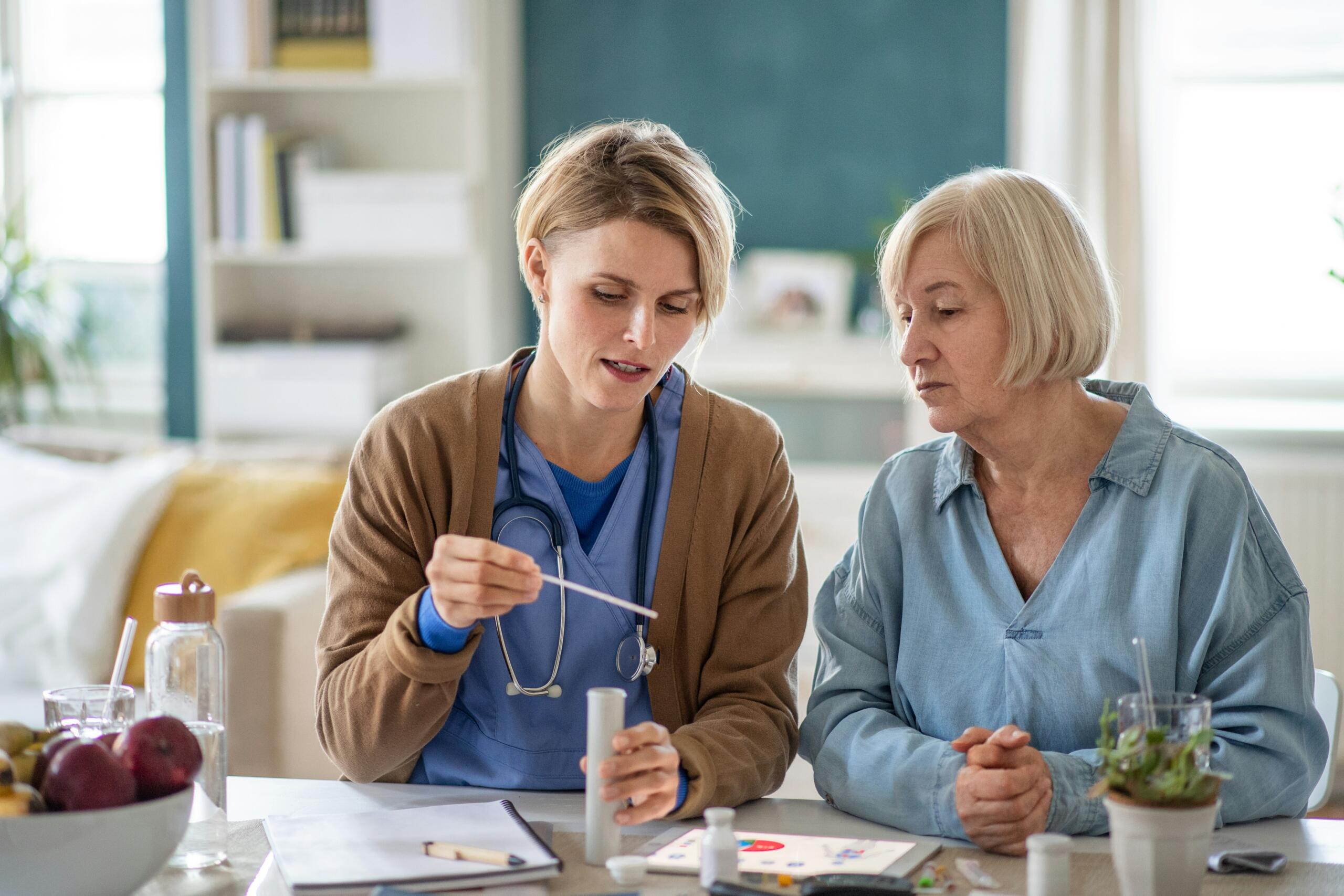 female nurse looking at test results with an elderly patient