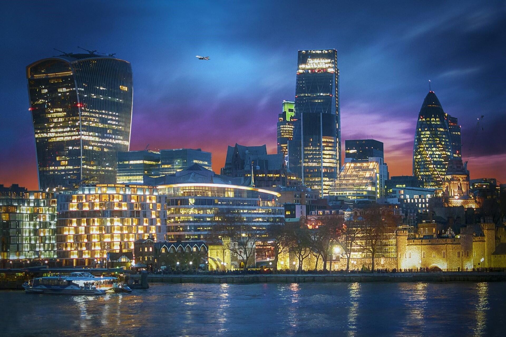 A view of business buildings at night in London.