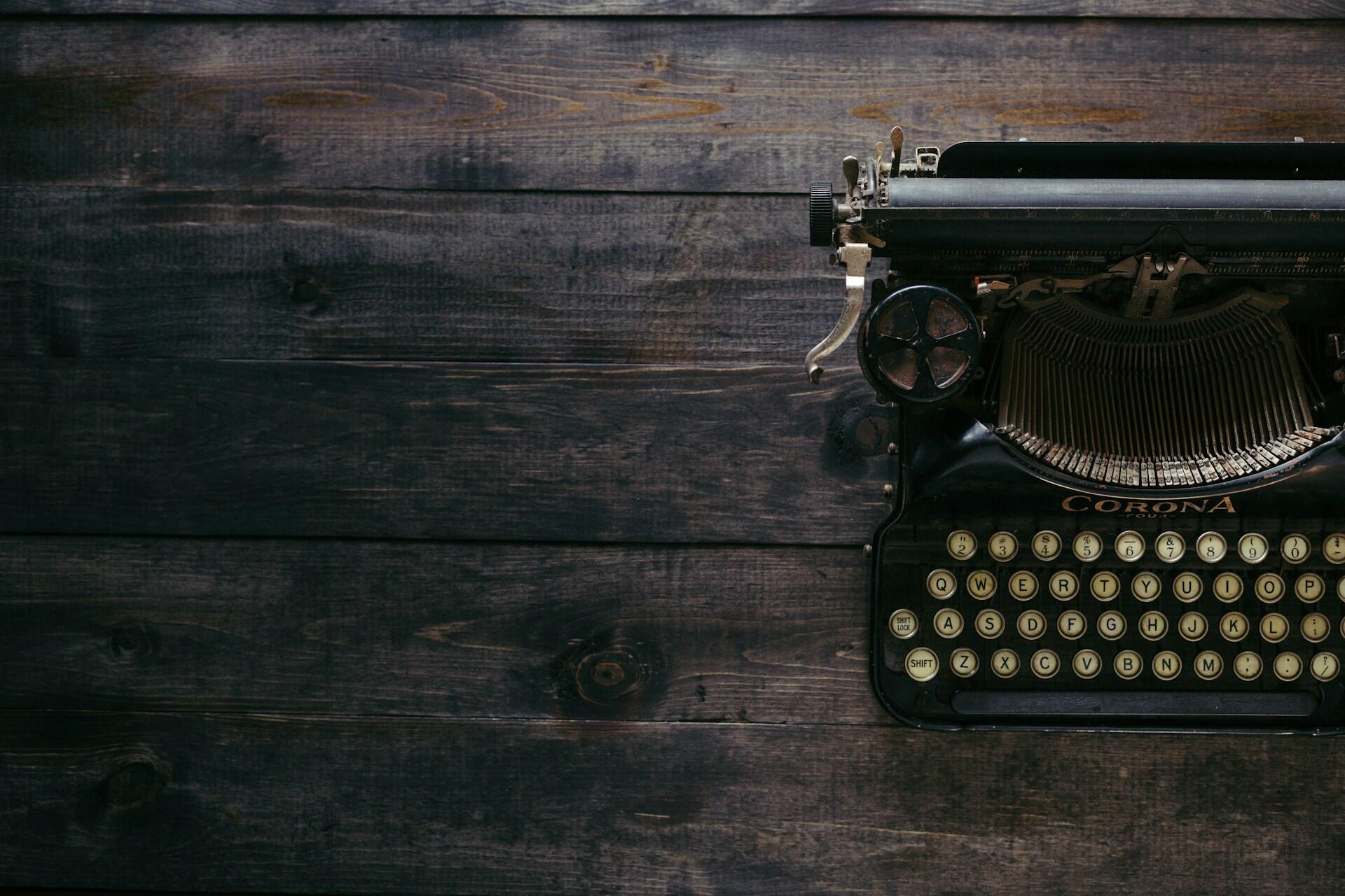 A typewriter on a wooden surface.