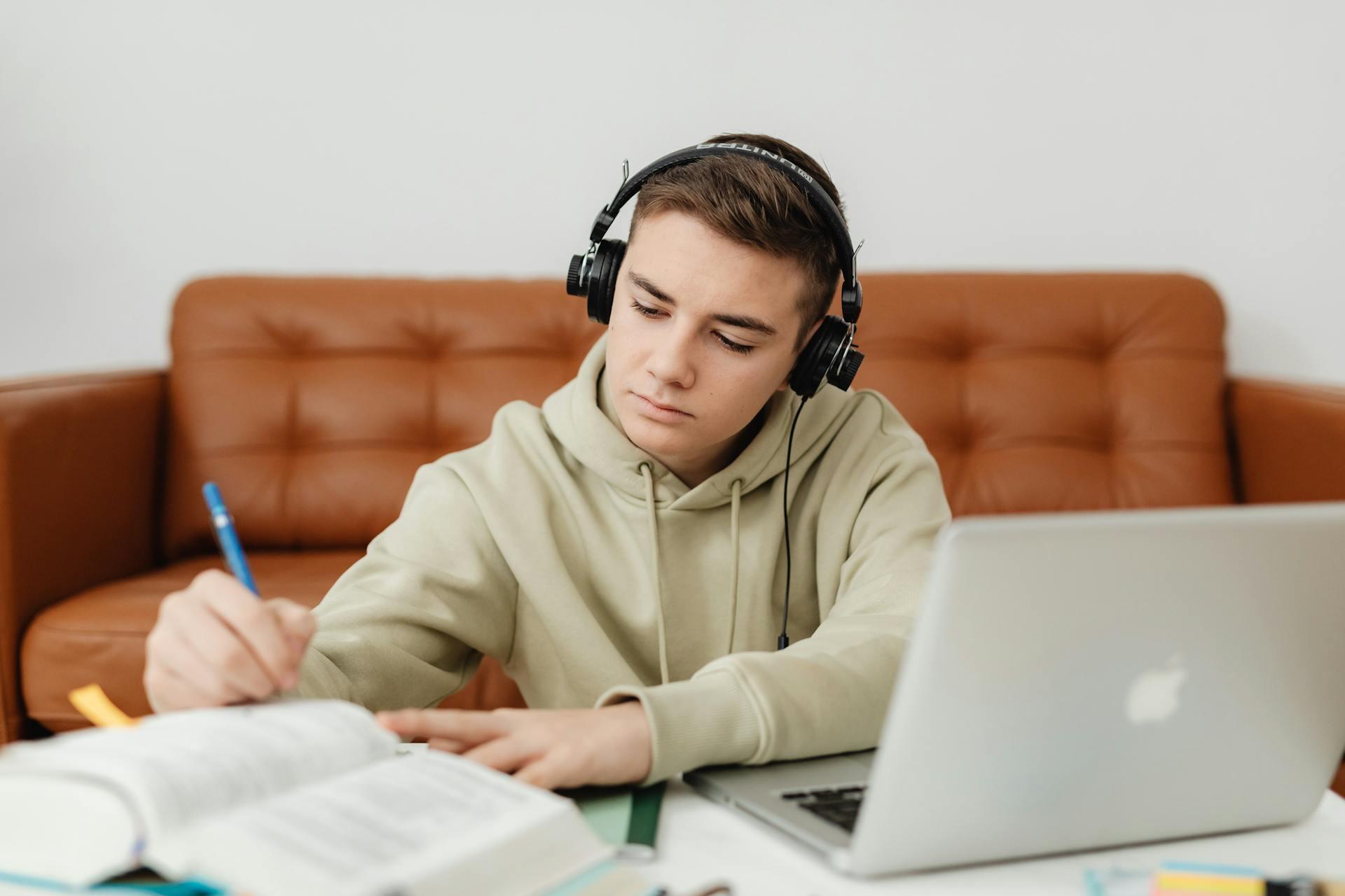 kid with headphones on studying