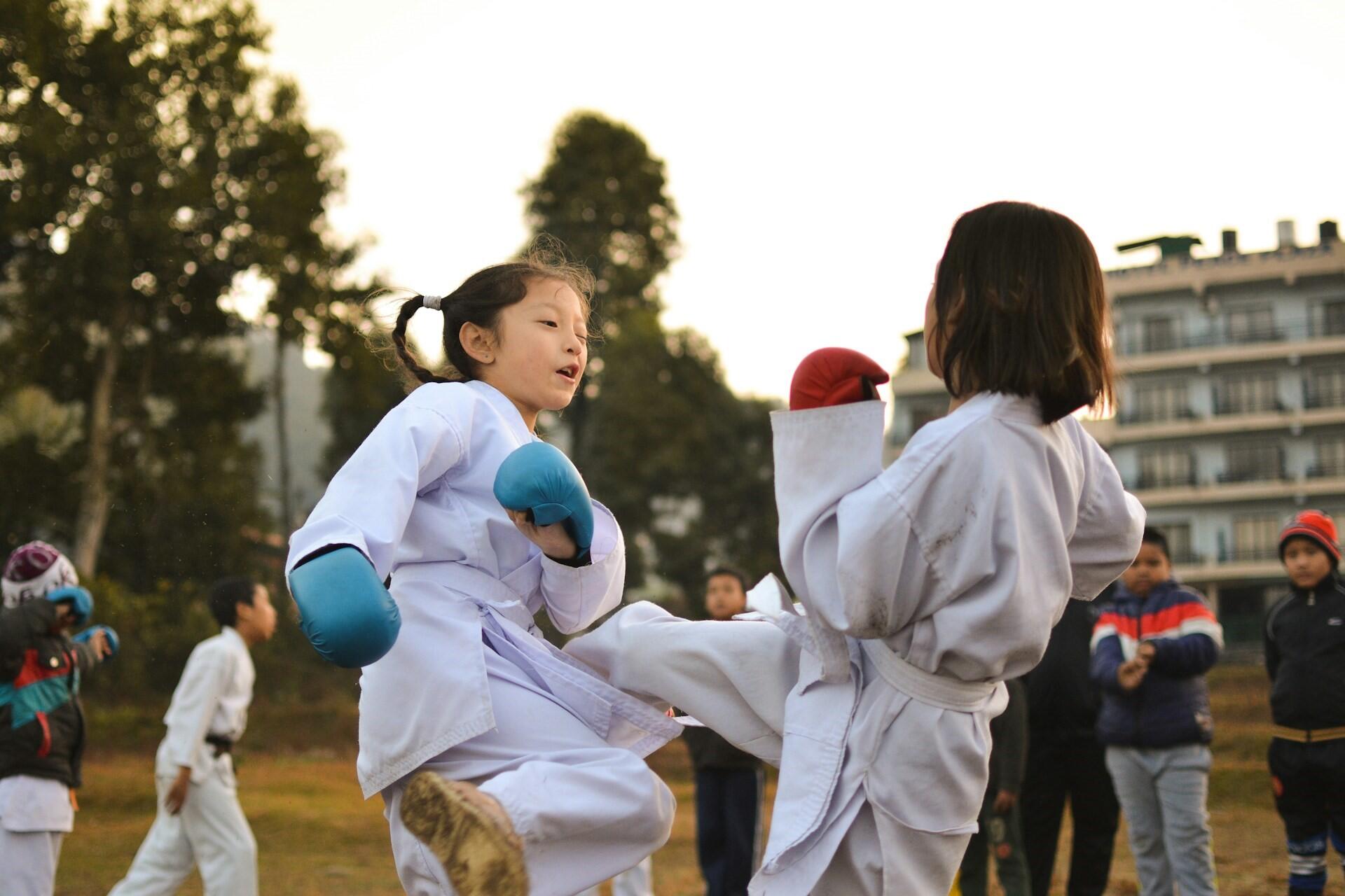 Two young children sparring.
