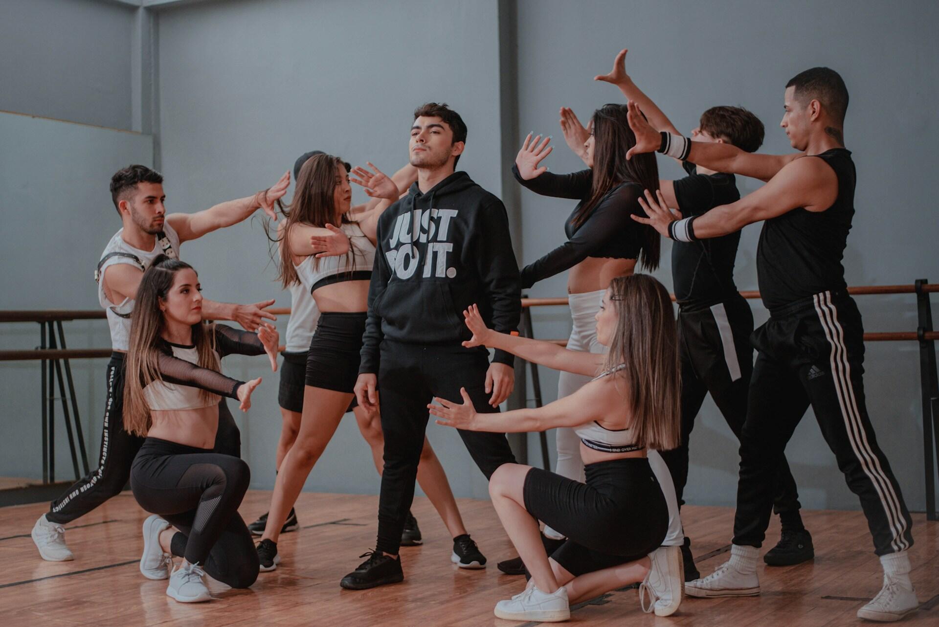 Group of dancers practising a routine together in a studio