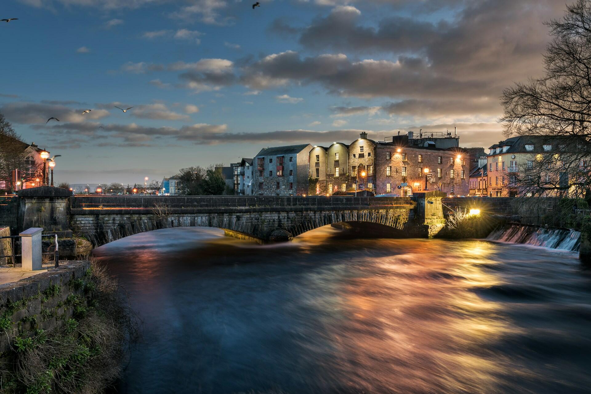 A view of Galway, a bridge, and a river.