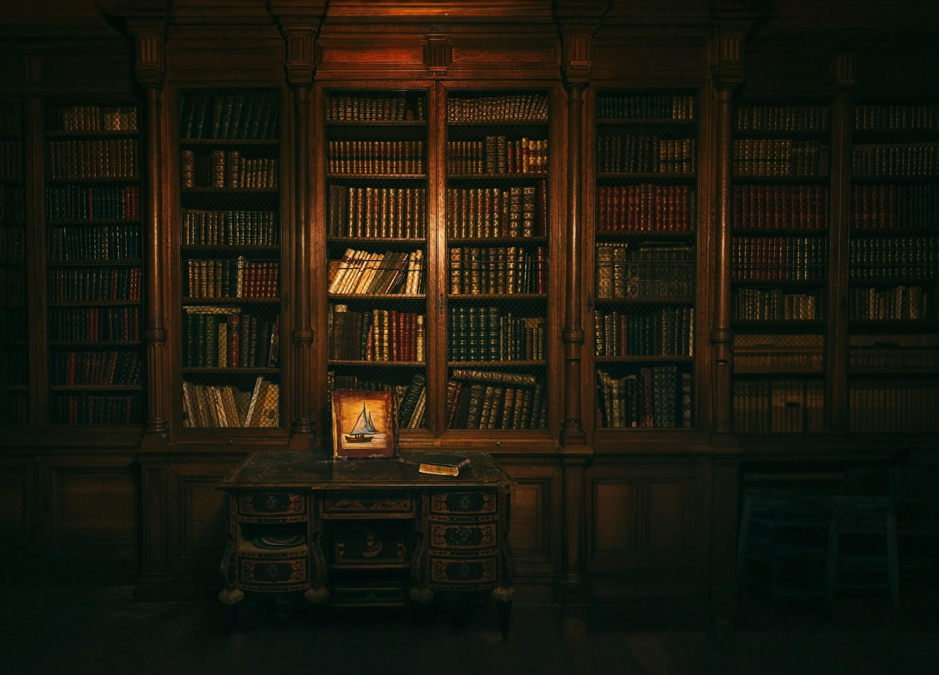 An antique wooden bookcase stacked with ancient books.