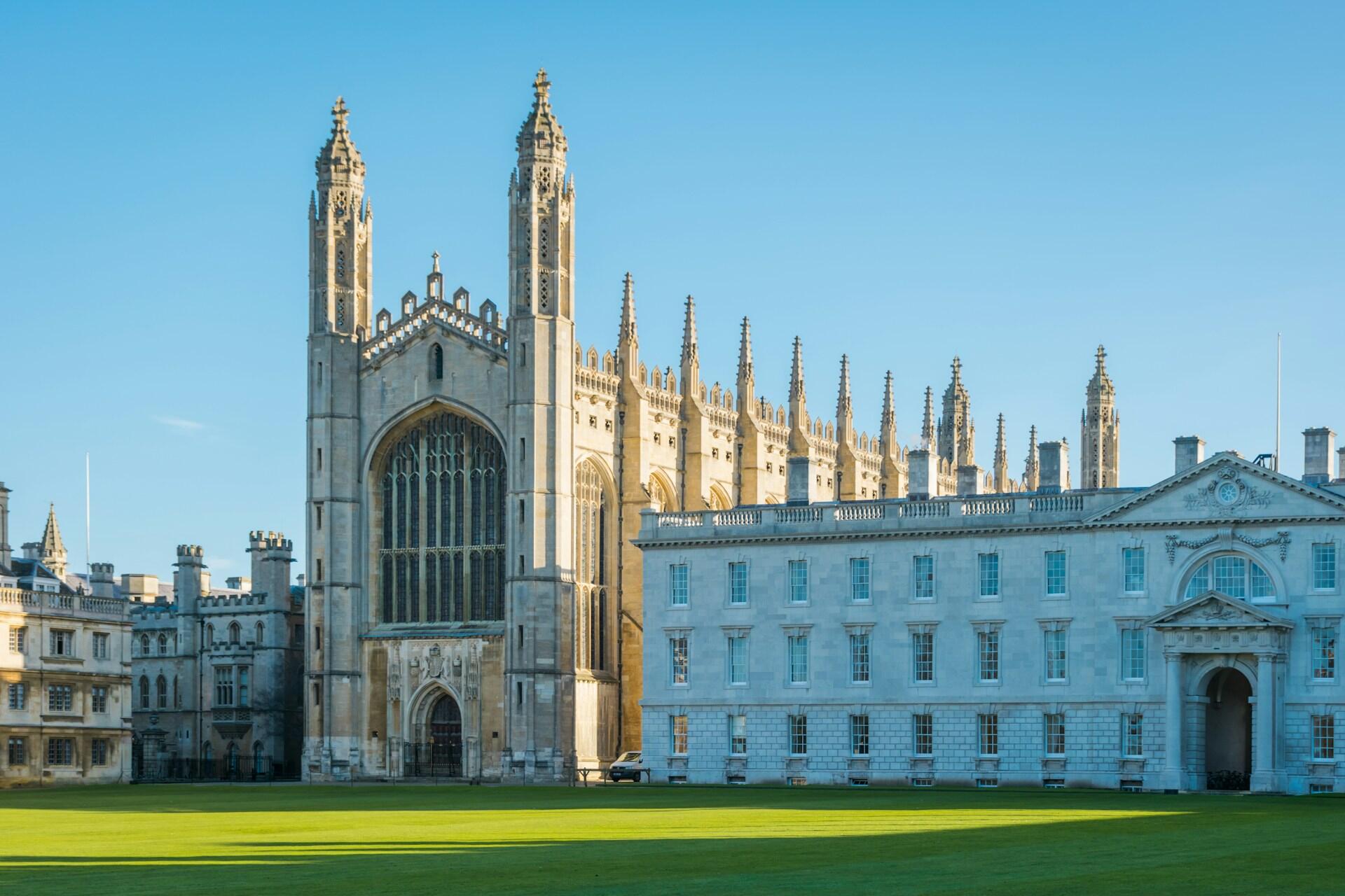 A large stone building and green space on a sunny day. 