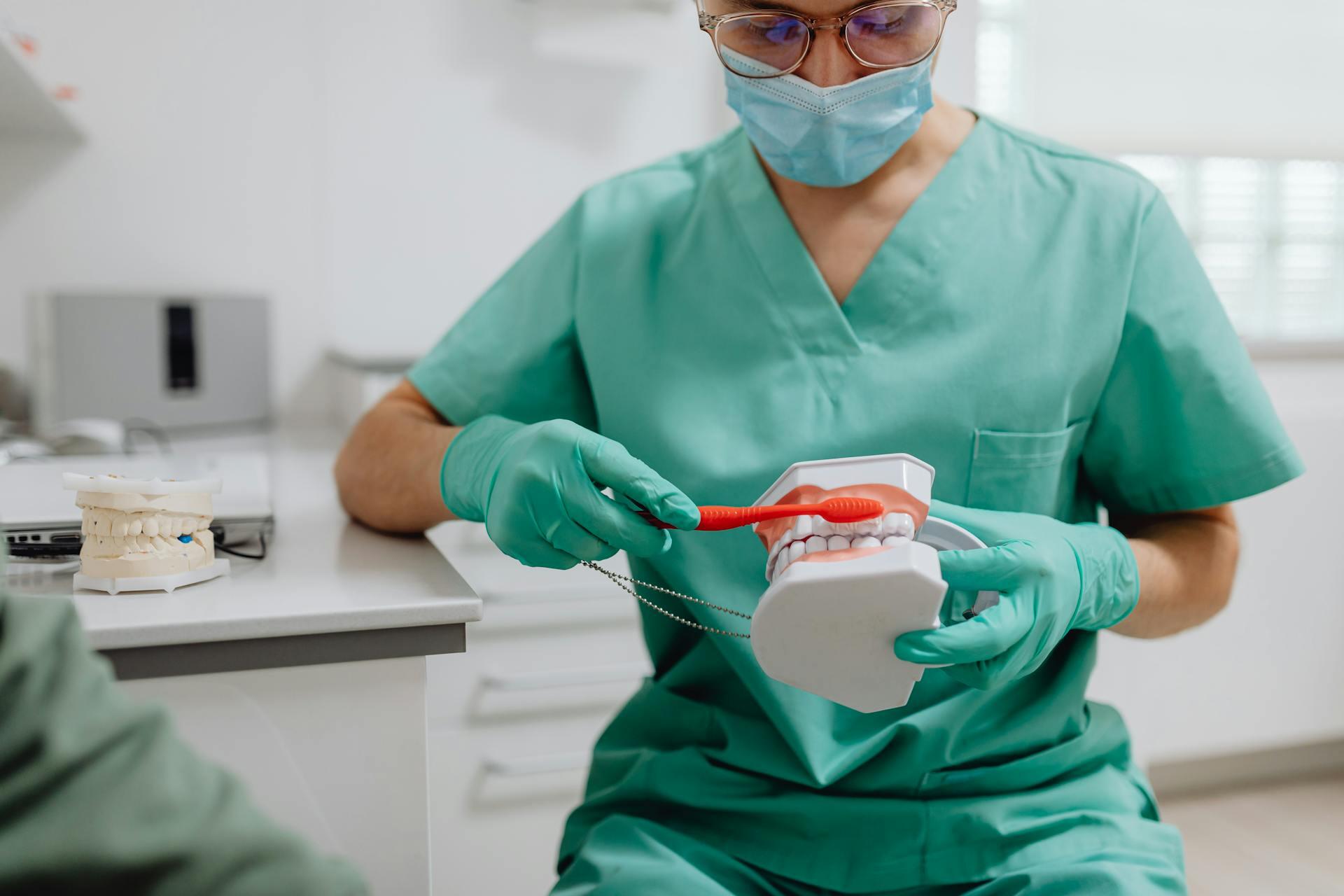 nurse practicing on fake teeth