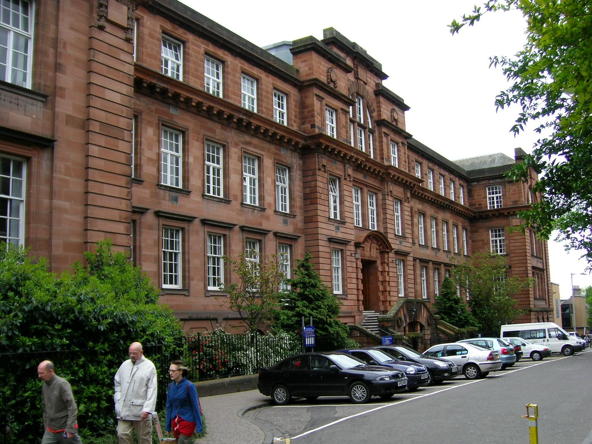 A large red brick building on a cloudy day. 