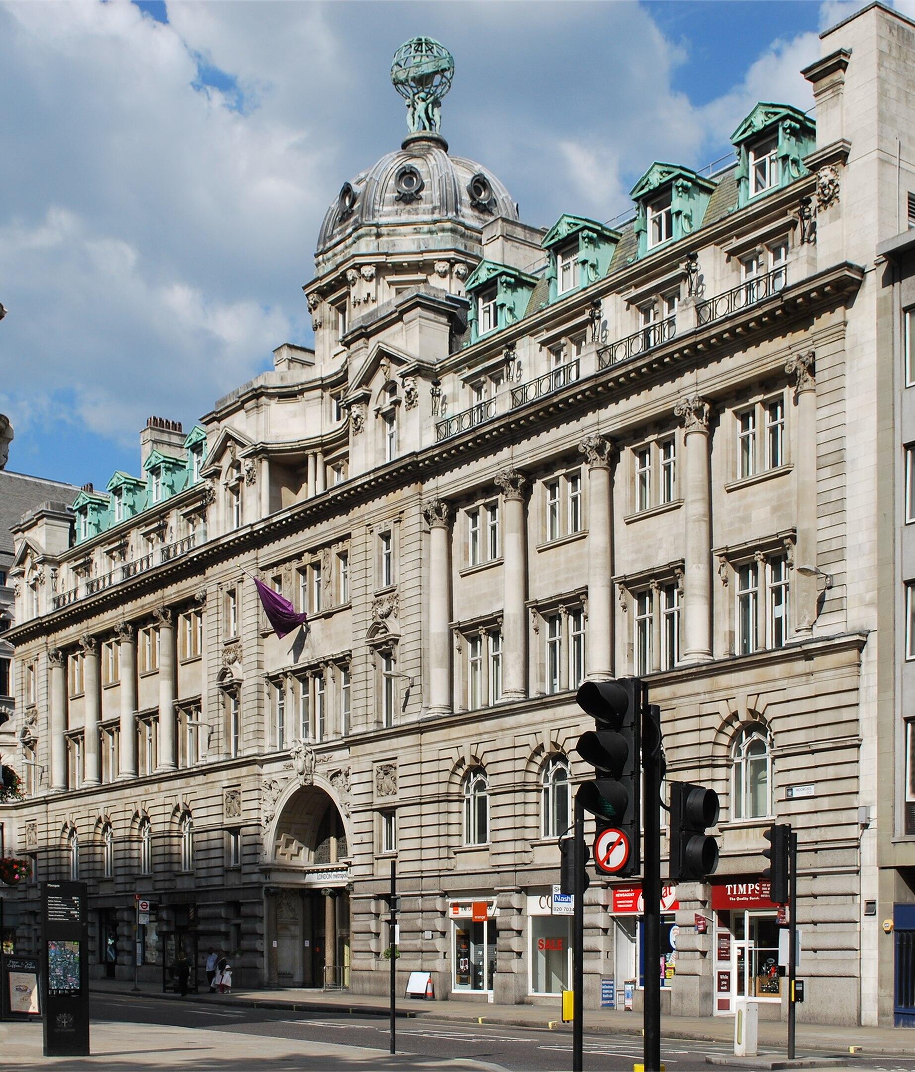 A light-coloured stone building on a sunny day.