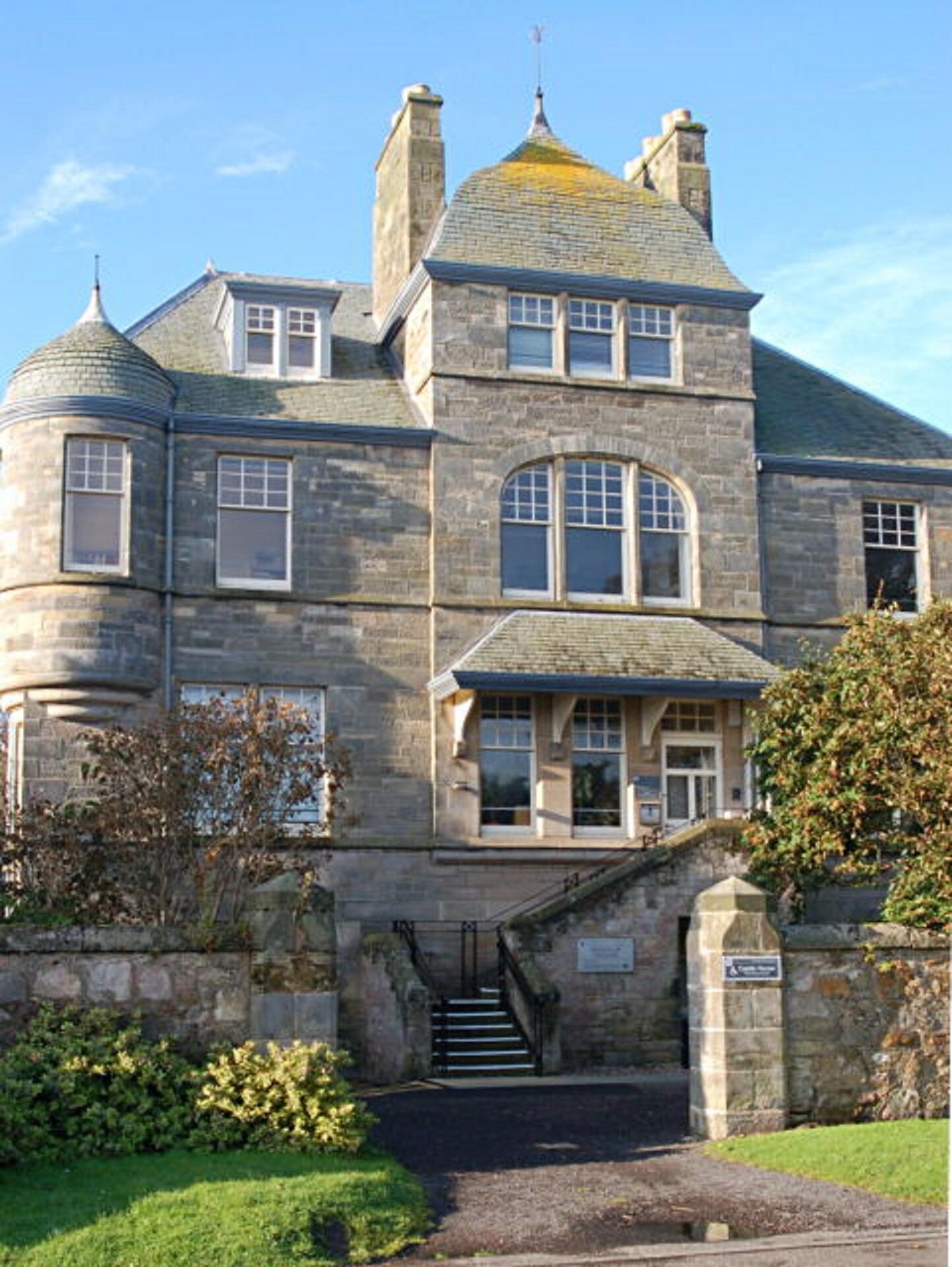 A tall stone building on a sunny day.