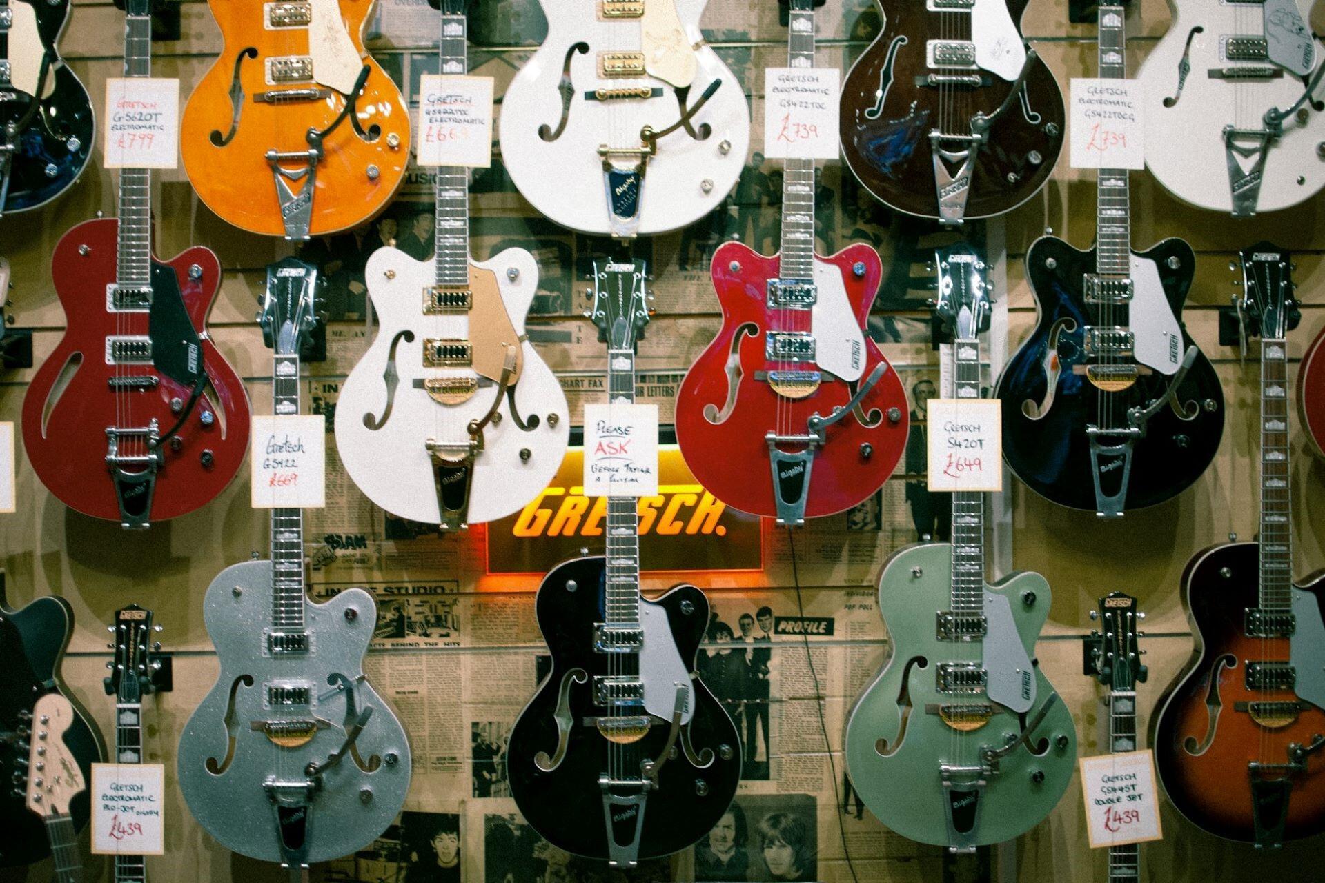 Gretsch guitars on a wall in a store.