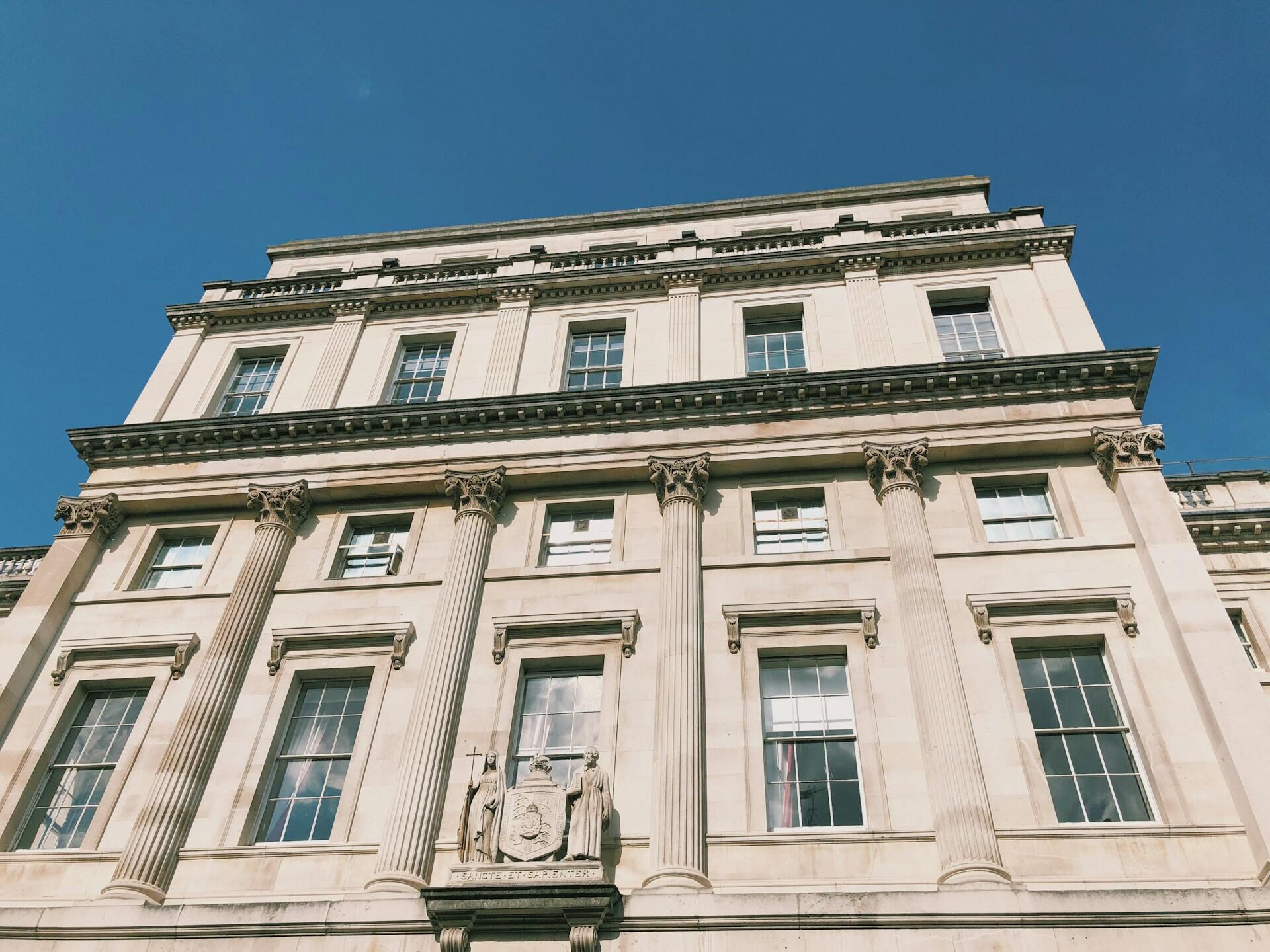 A large light coloured building on a sunny day.
