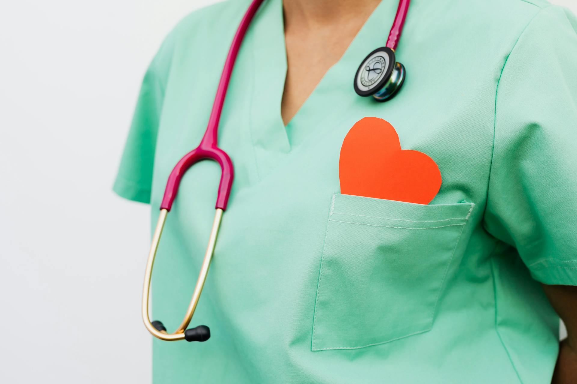 Nurse in green outfit with heart in pocket