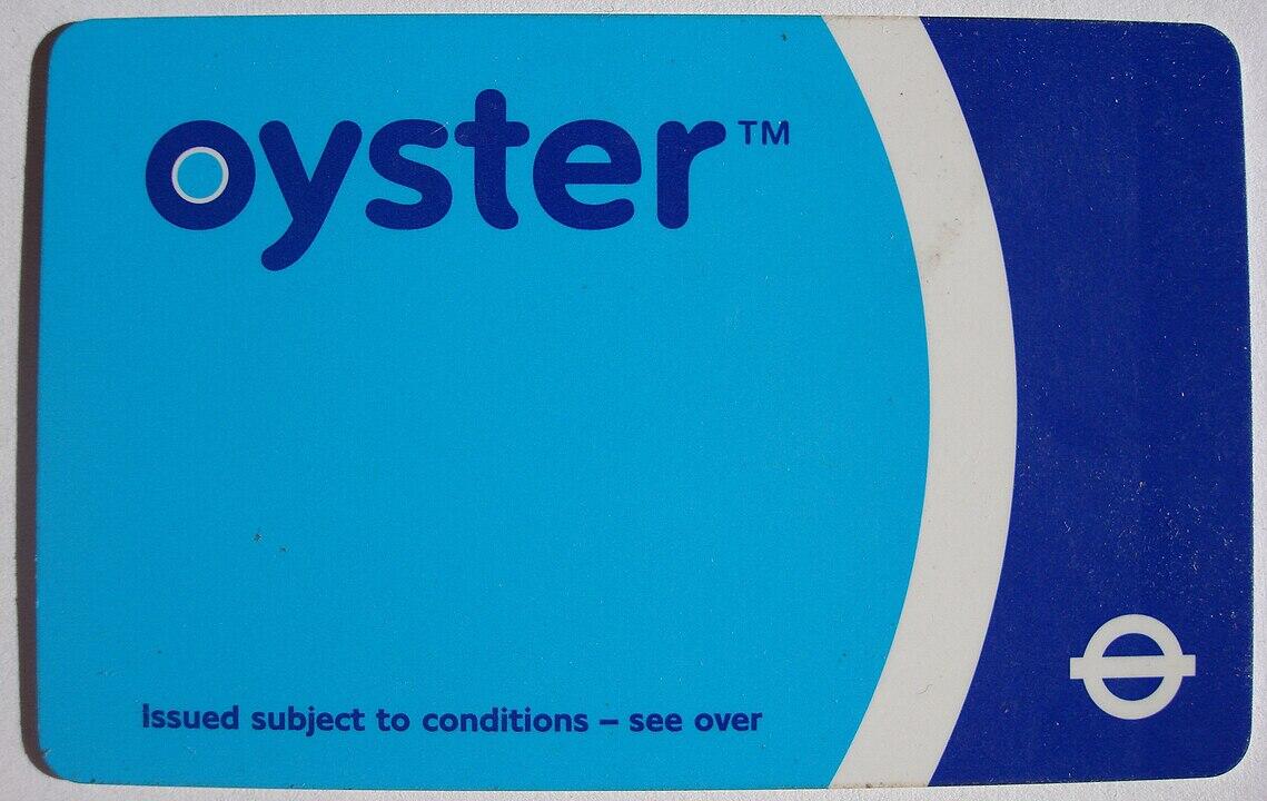 A blue Oyster card with white text, labeled "oyster™," used for public transport in London, featuring a circular logo.