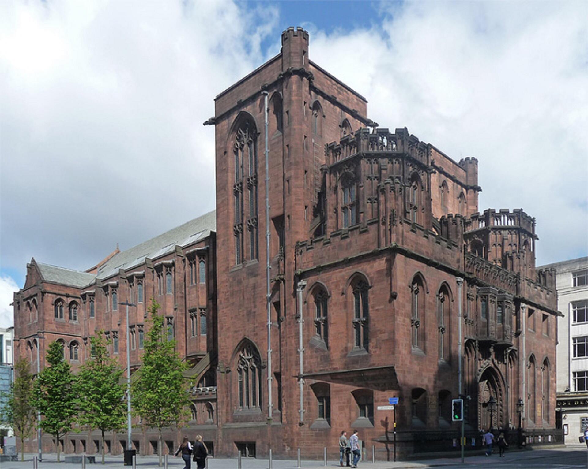 A large dark stone building on a cloudy day. 
