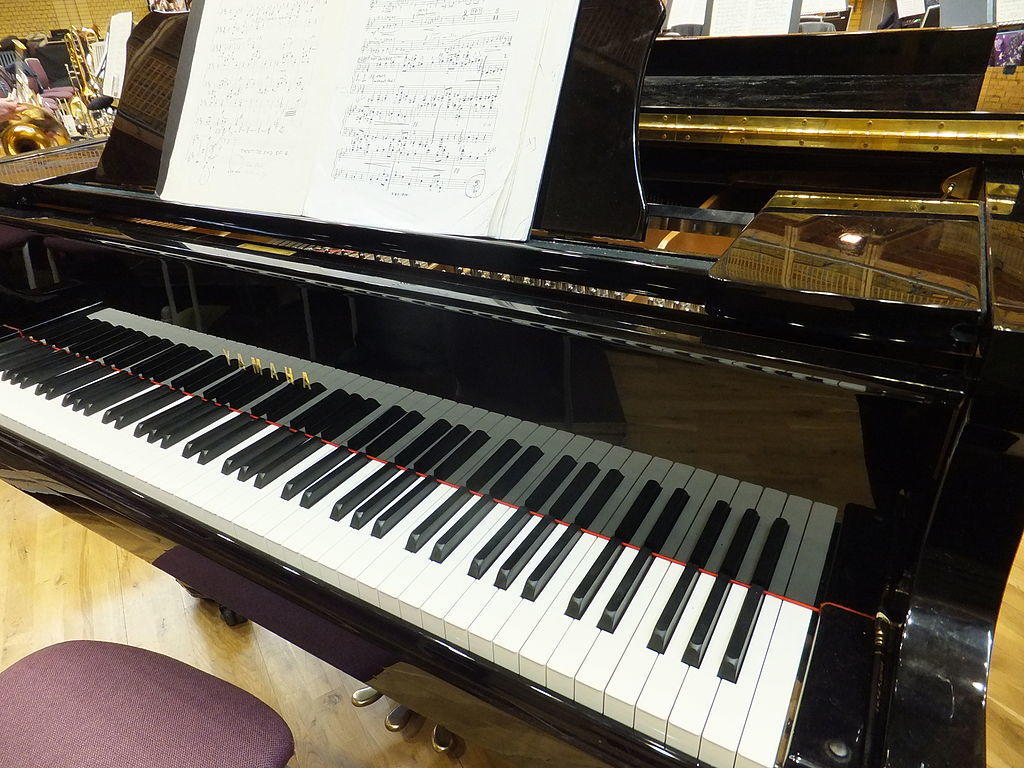 room with a piano and sheet music open