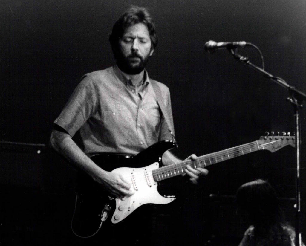 Eric Clapton making beautiful sounds on his guitar.