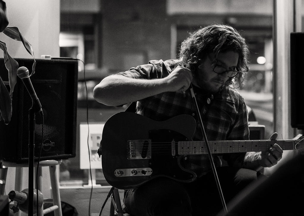 A guitarist practicing technique in the studio