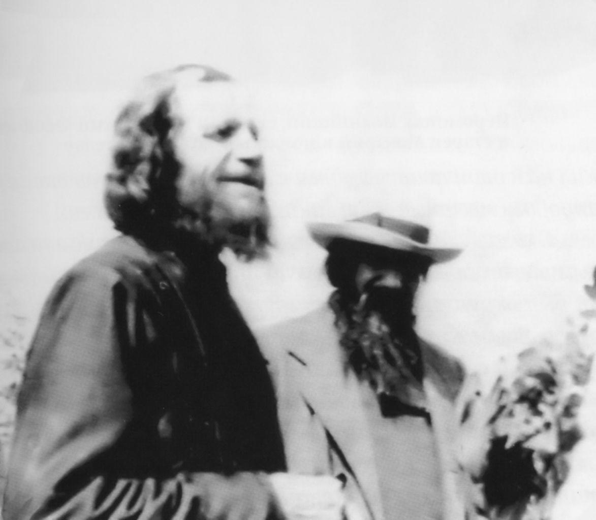 an old photograph of two elderly men with a beard in black and white