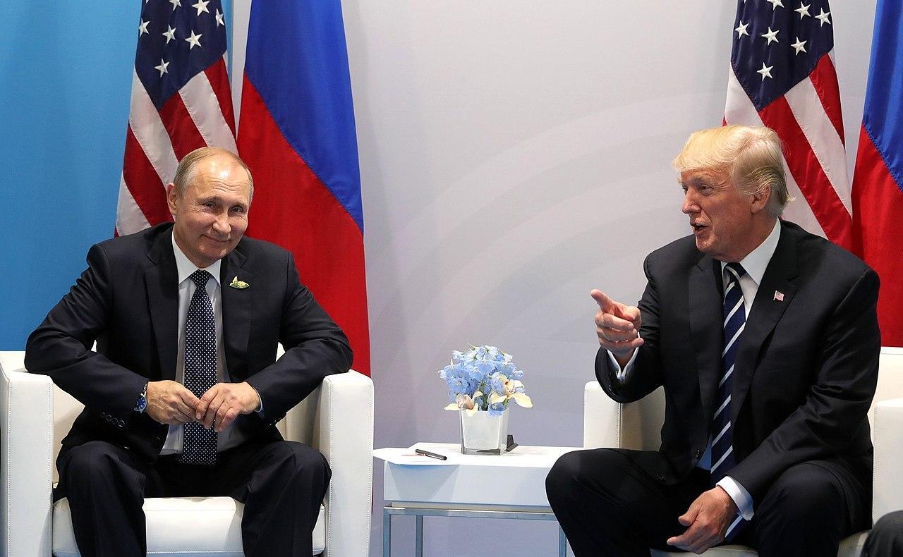 president putin seated with donald trump in a conference