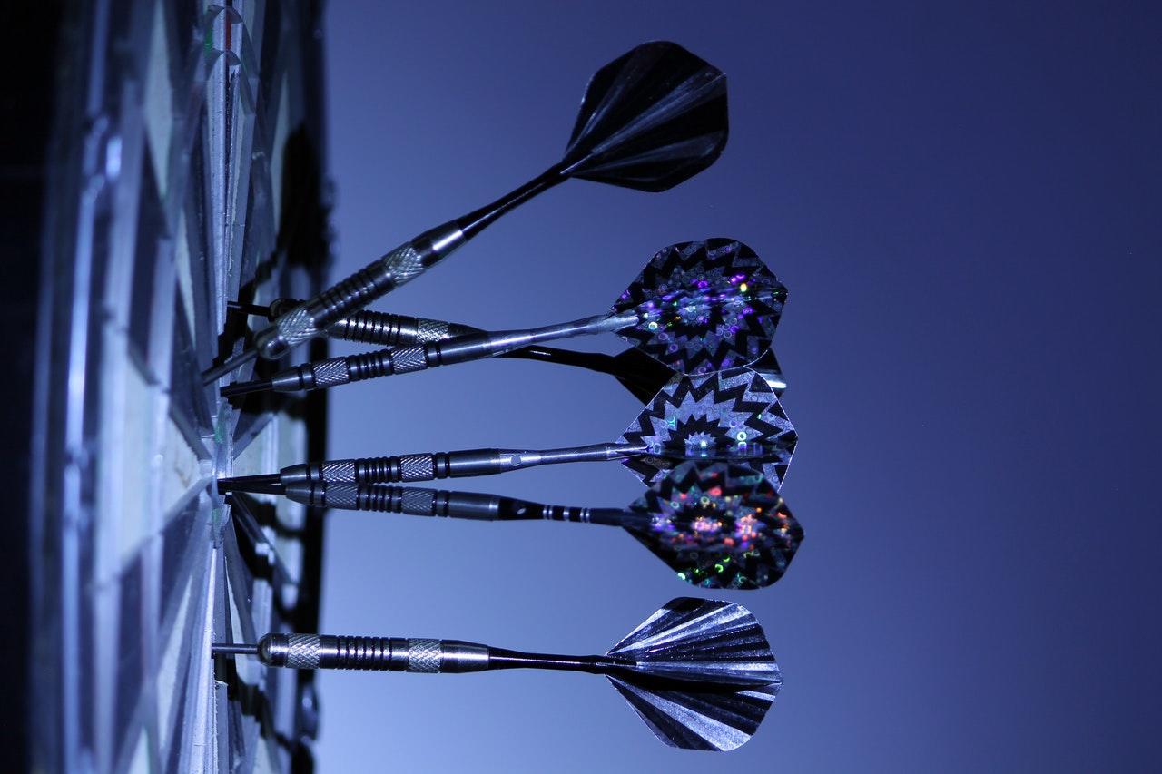 darts placed on a dartboard
