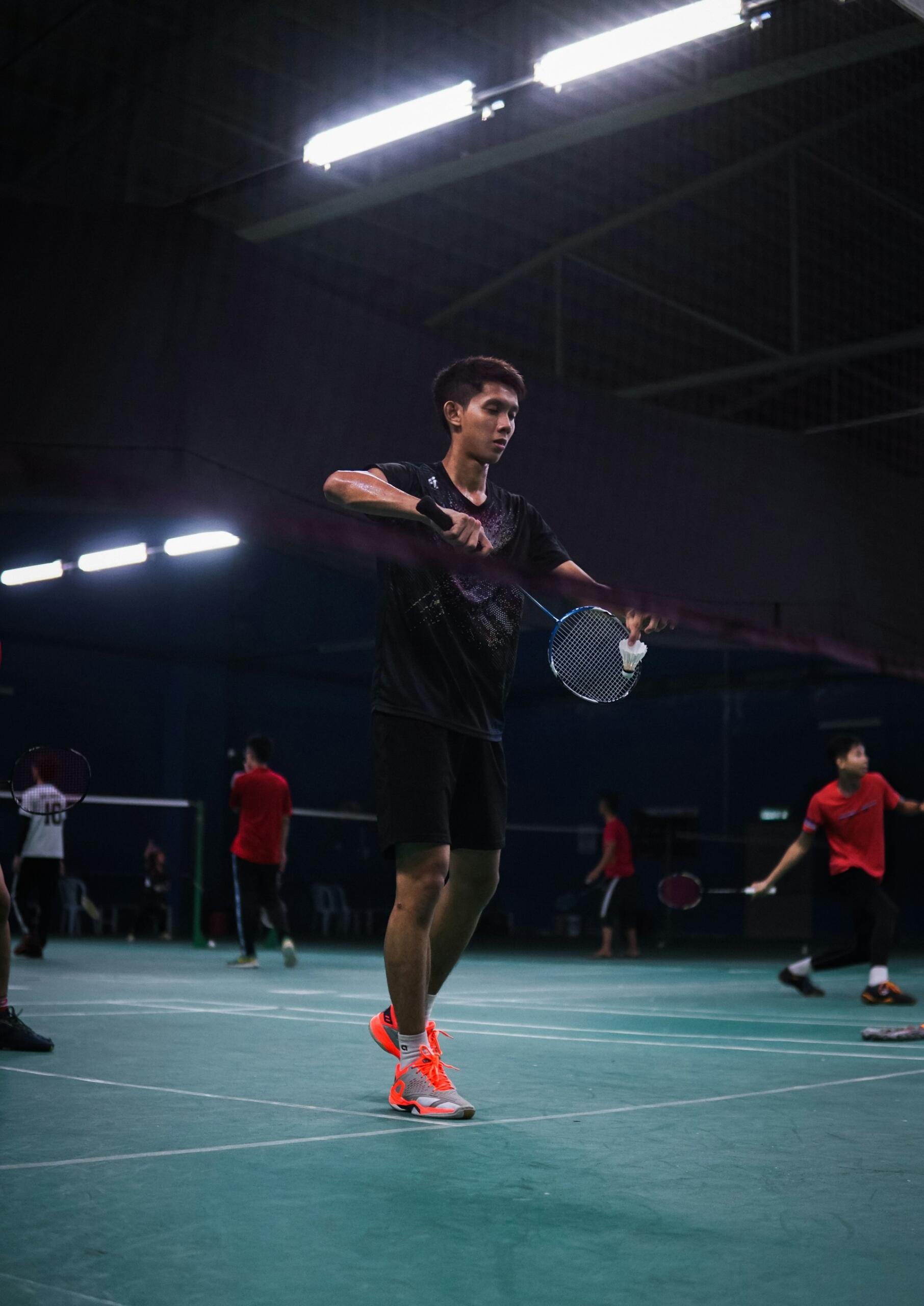 A man preparing to serve in badminton